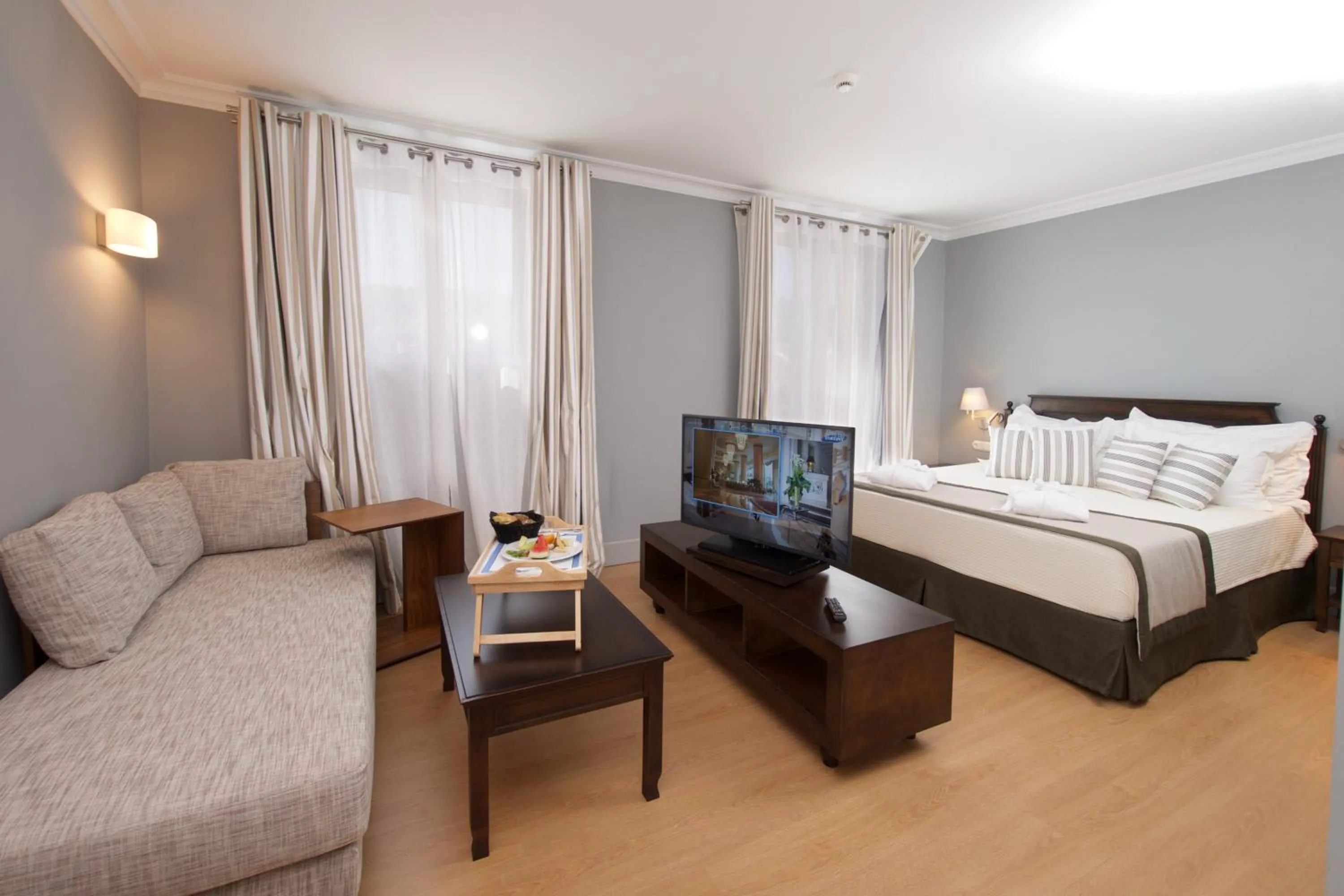 Seating area, Bed in Aenos Hotel