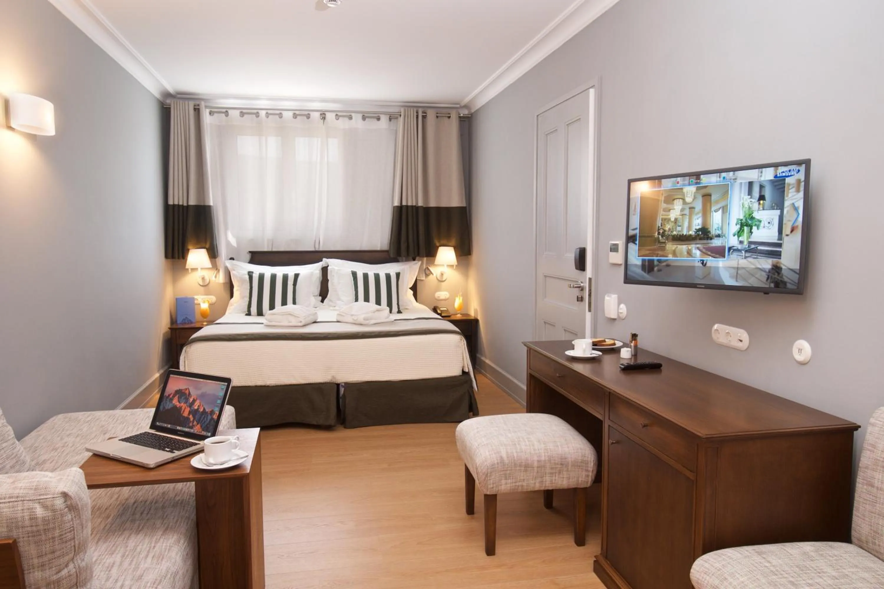 Seating area, Bed in Aenos Hotel