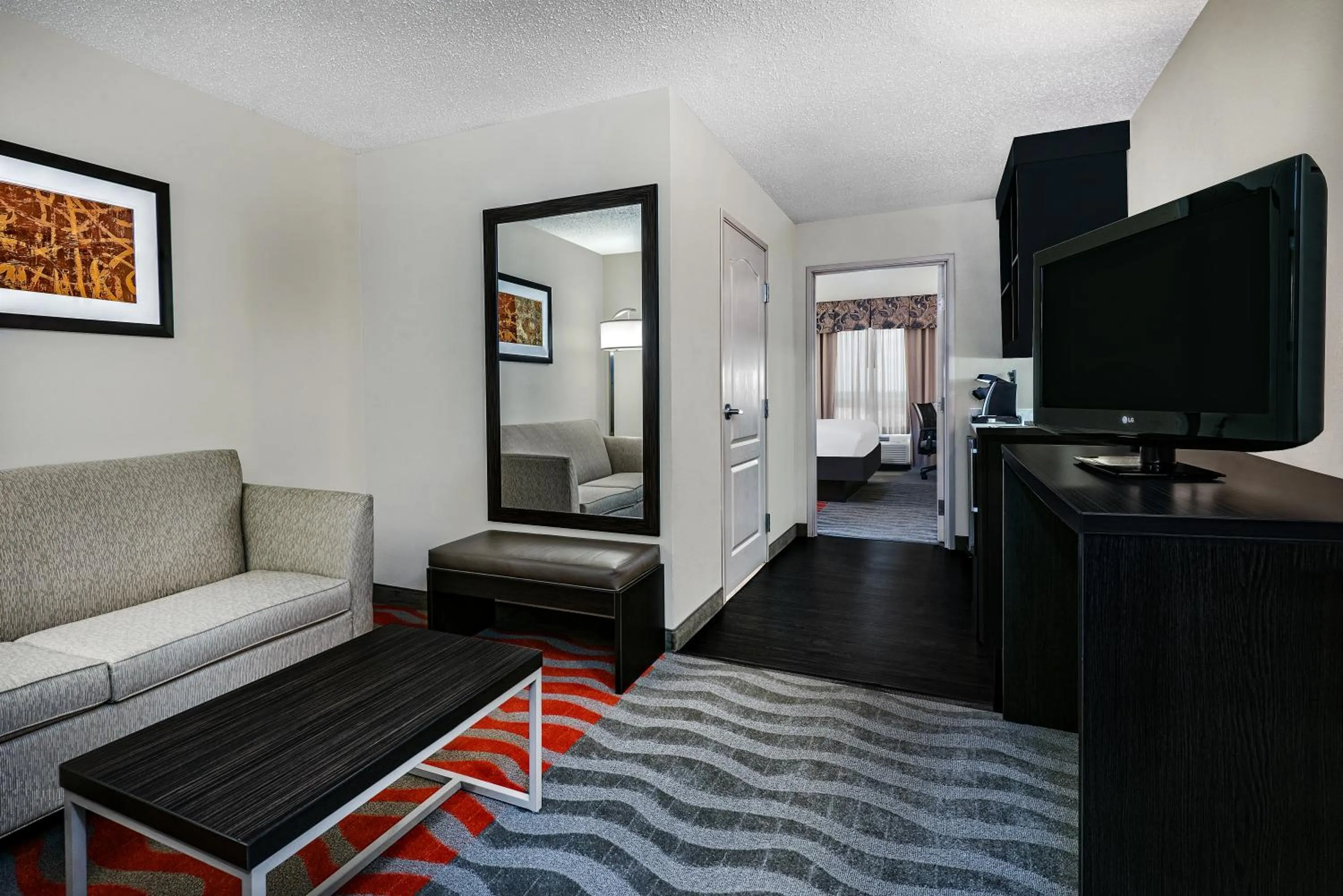 Communal lounge/ TV room, Bed in Holiday Inn & Suites College Station-Aggieland by IHG
