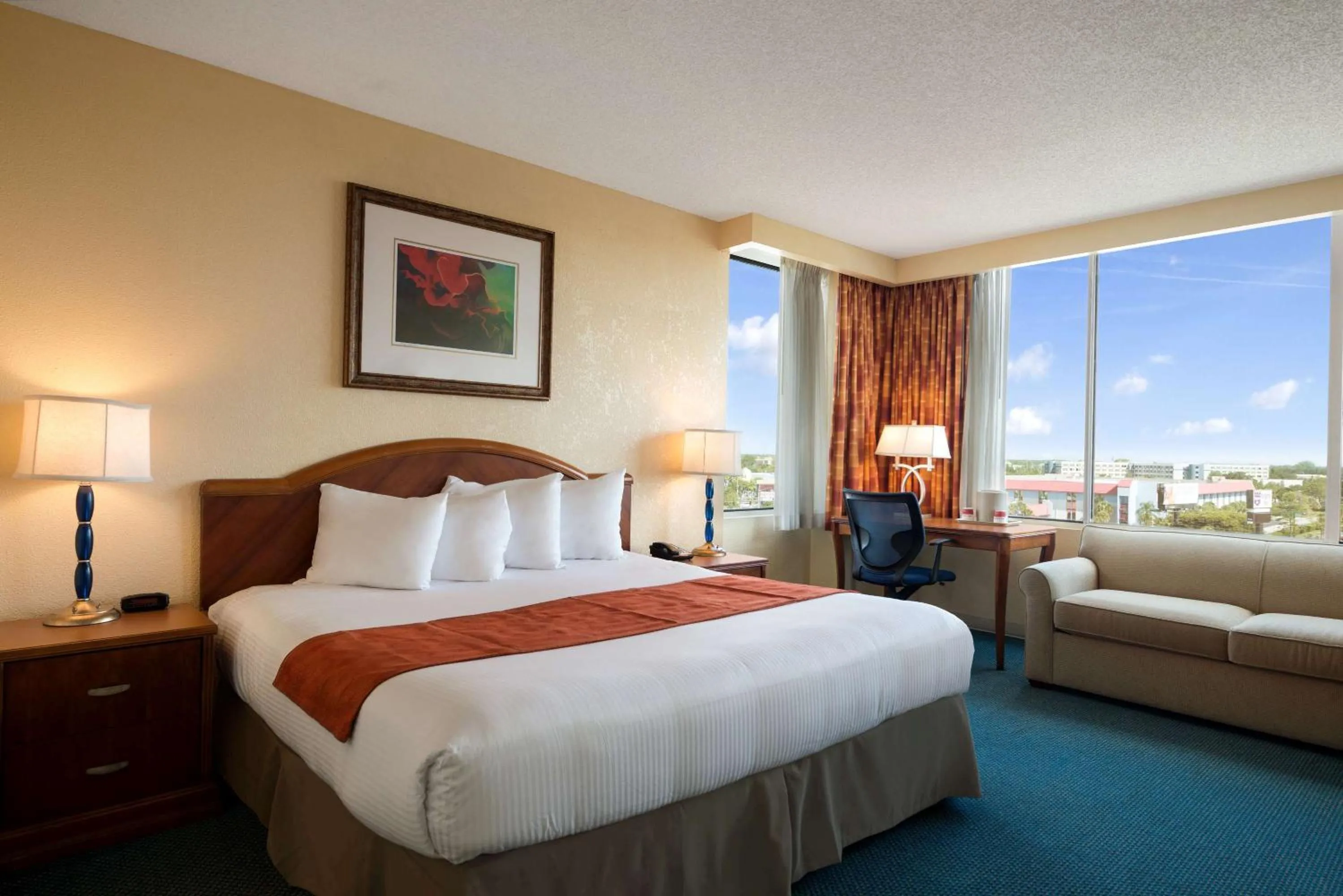Photo of the whole room, Bed in Ramada by Wyndham Kissimmee Gateway - Free Theme Park Shuttle