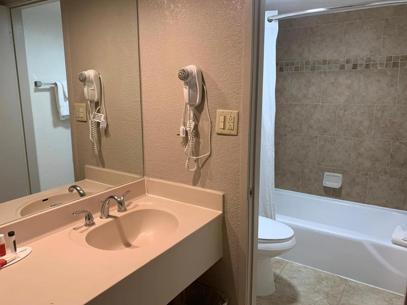 Bathroom in Ramada by Wyndham Kissimmee Gateway - Free Theme Park Shuttle