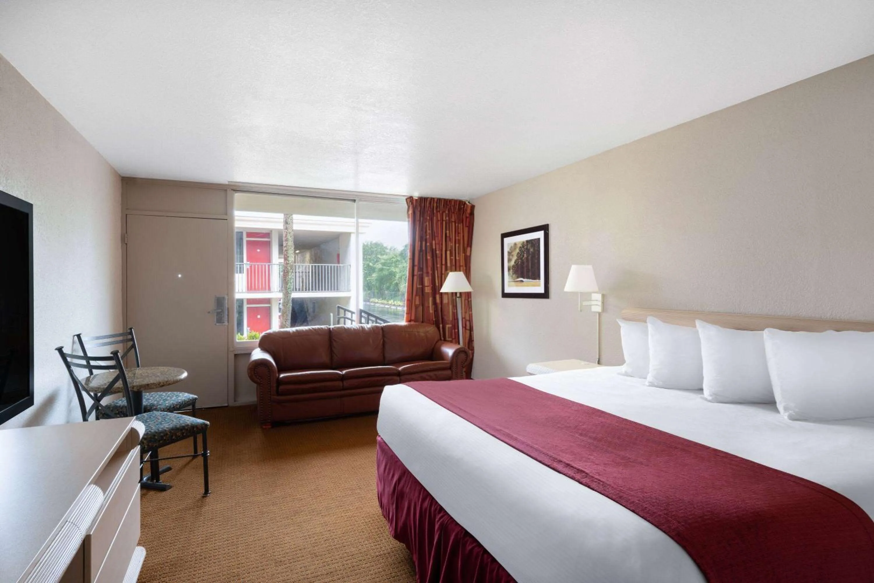 Photo of the whole room, Bed in Ramada by Wyndham Kissimmee Gateway - Free Theme Park Shuttle