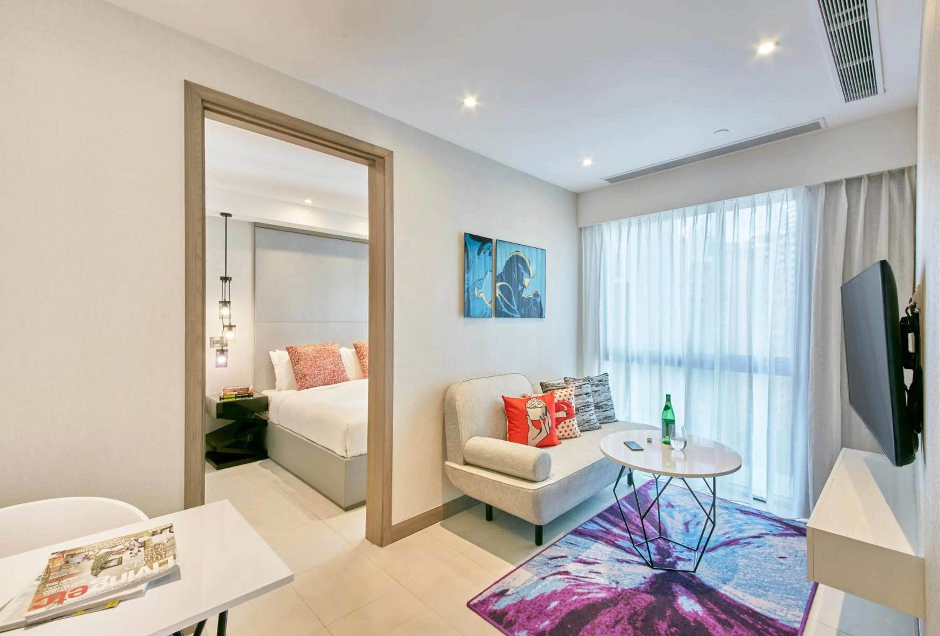 Dining area, Bed in Oakwood Studios Singapore