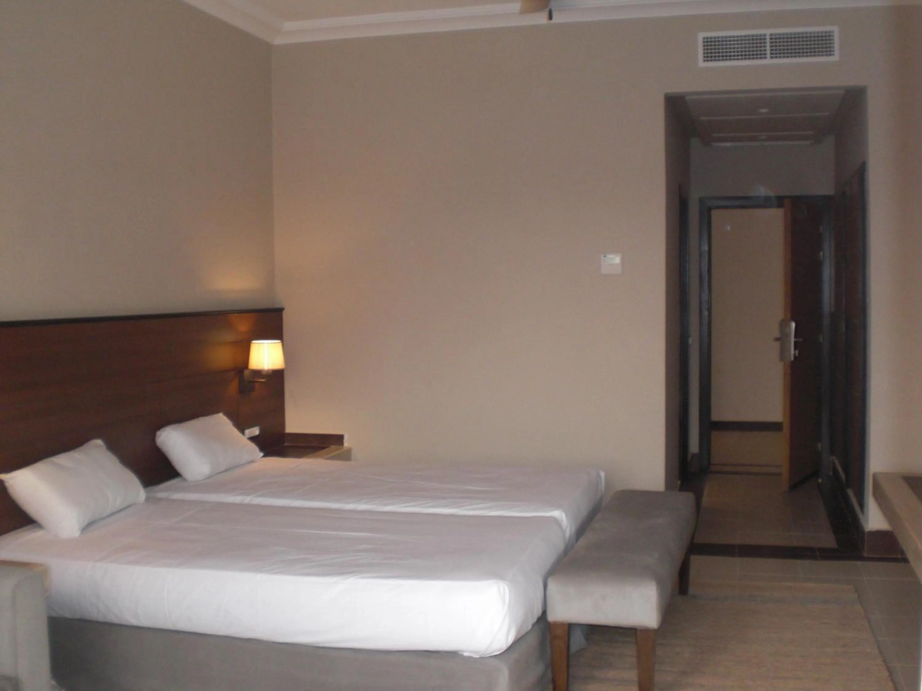 Bed in Oasis Palm Hotel