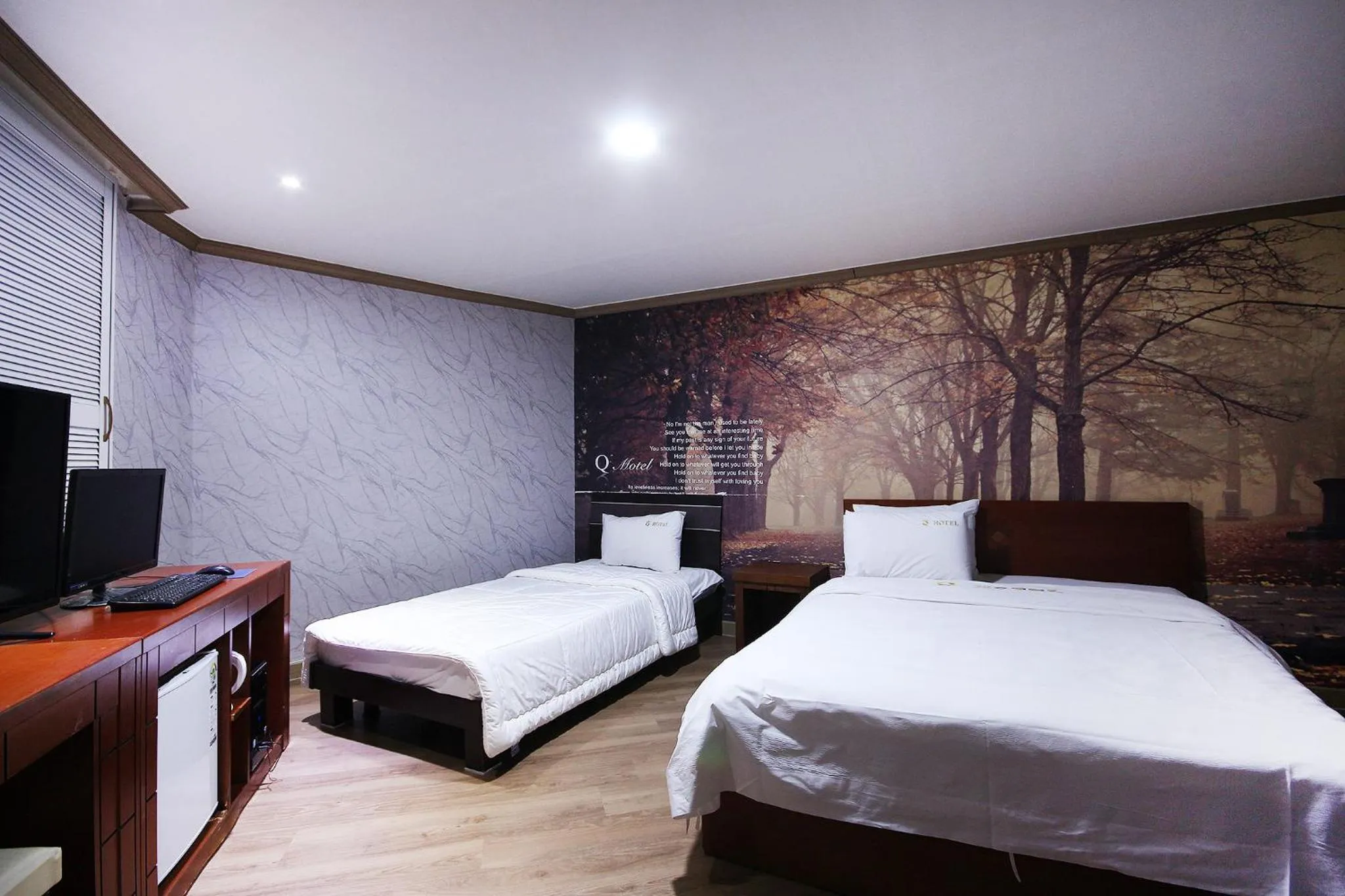 Bed in Happy Q Motel