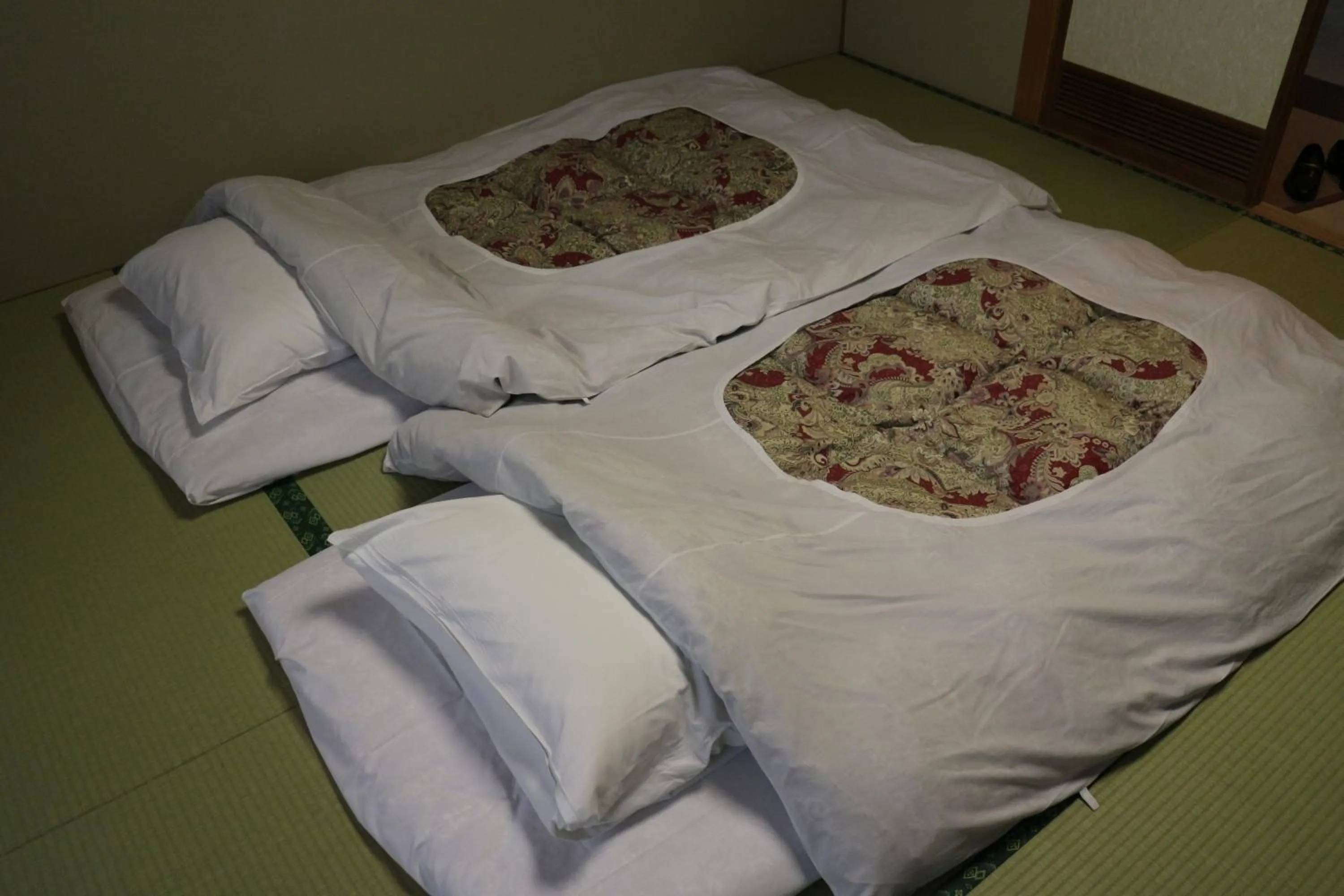 Bed in Hotel New Kotobuki