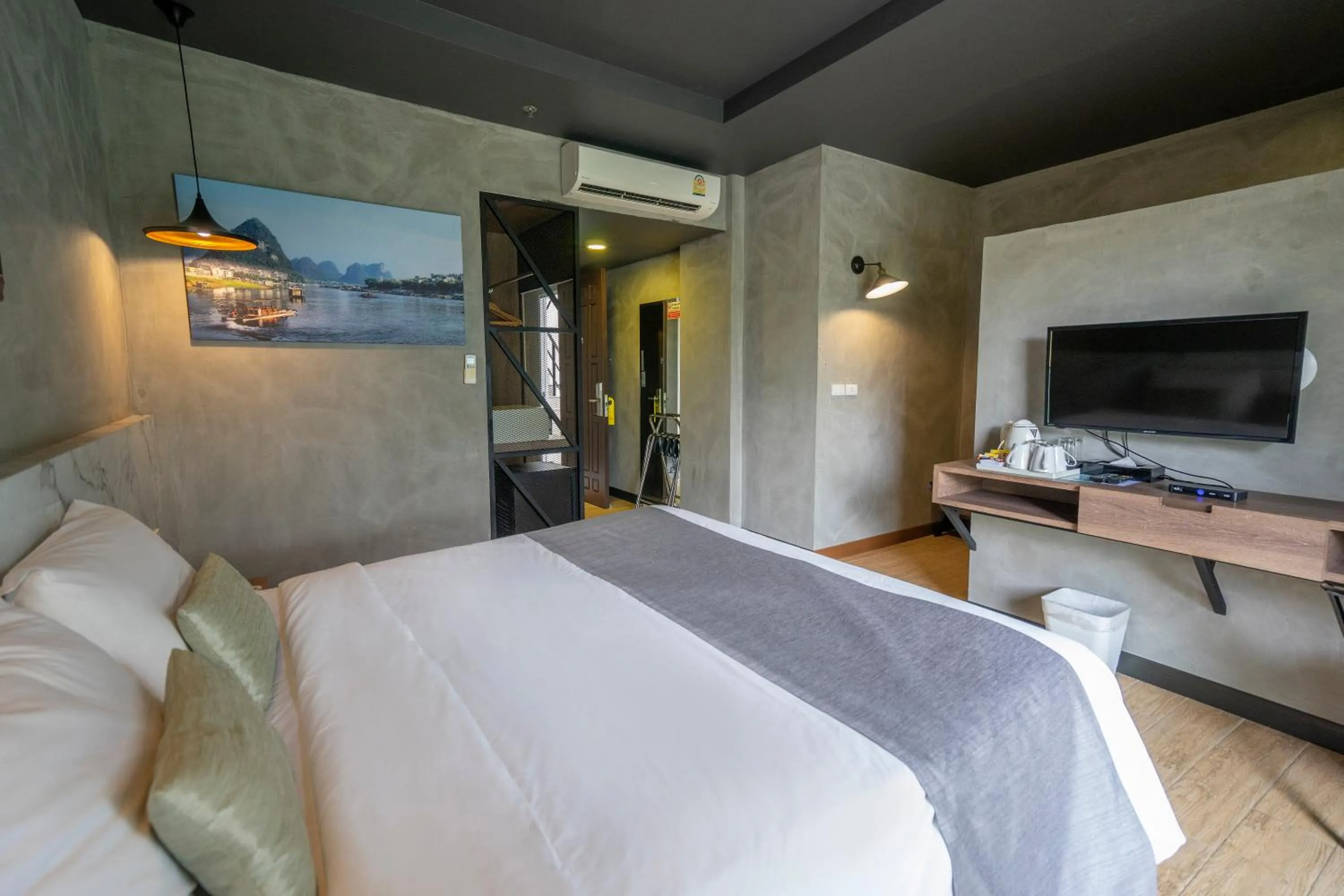 Bed in Chiangkhong Teak Garden Riverfront Onsen Hotel- SHA Extra Plus