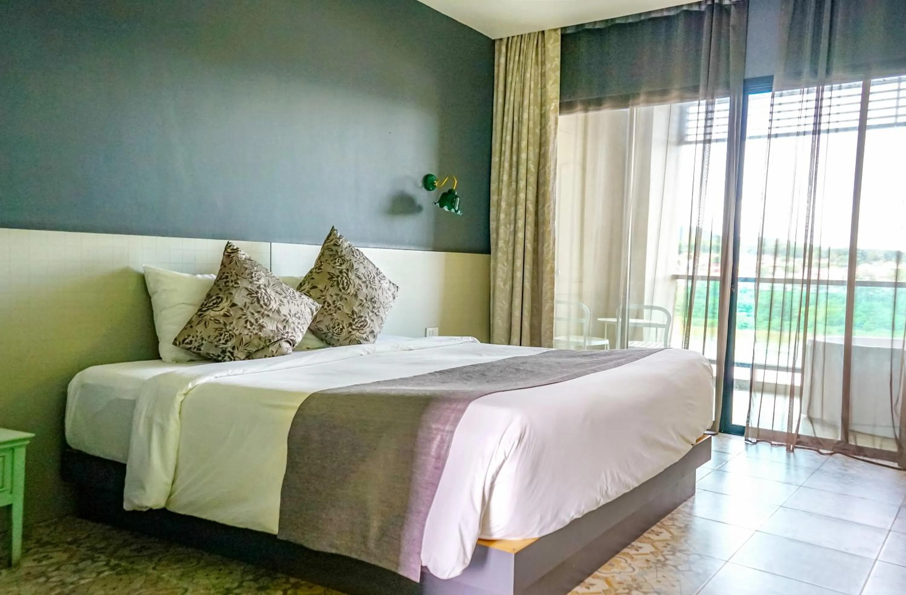 Bed in Chiangkhong Teak Garden Riverfront Onsen Hotel- SHA Extra Plus