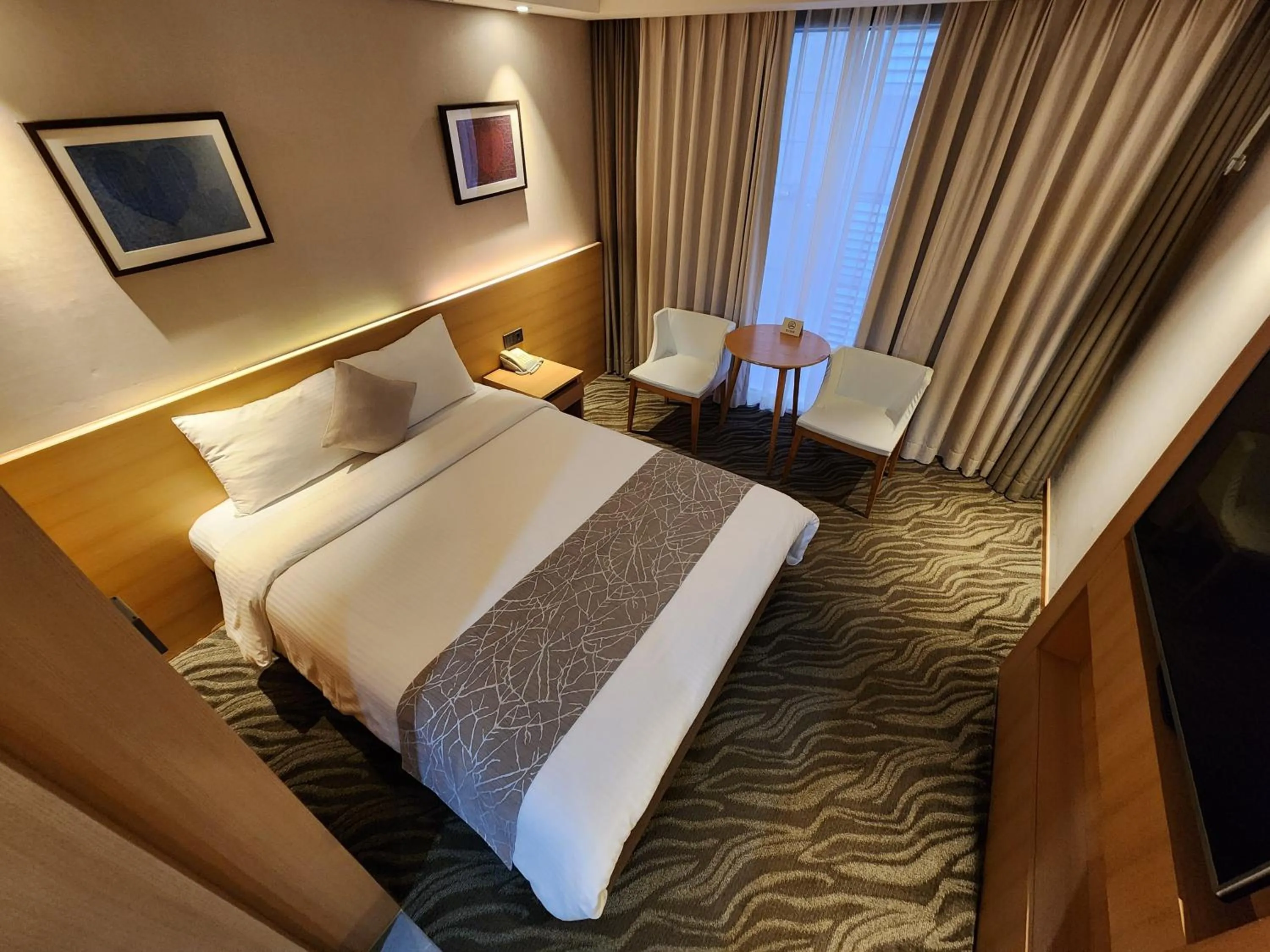 Bed in Seogwipo JS Hotel