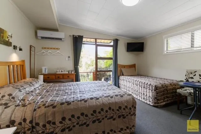 Bed in Waitomo Caves Guest Lodge