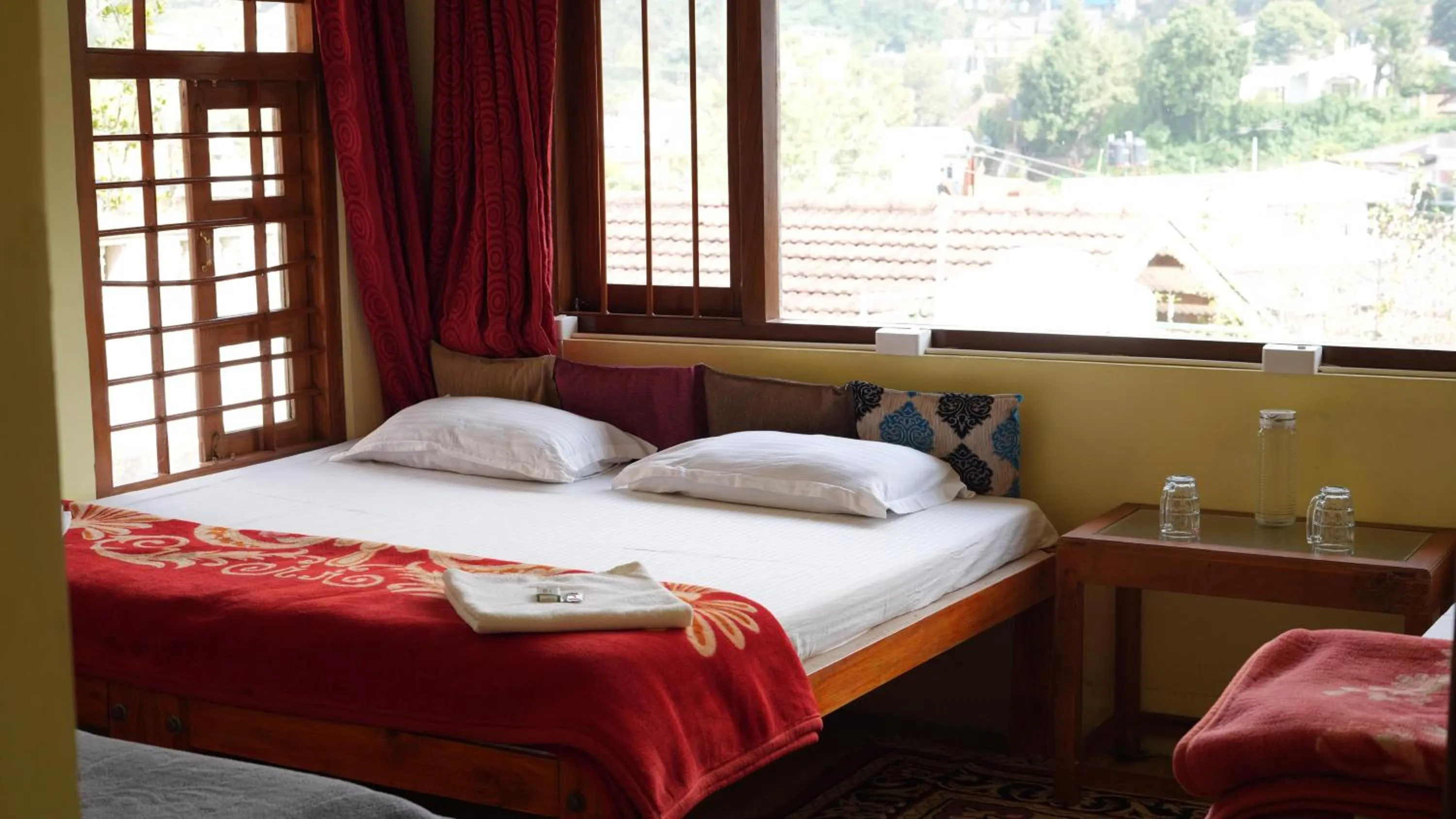 Bed in Satya Anand Cottage Pure Veg and Non Alcoholic Hotel