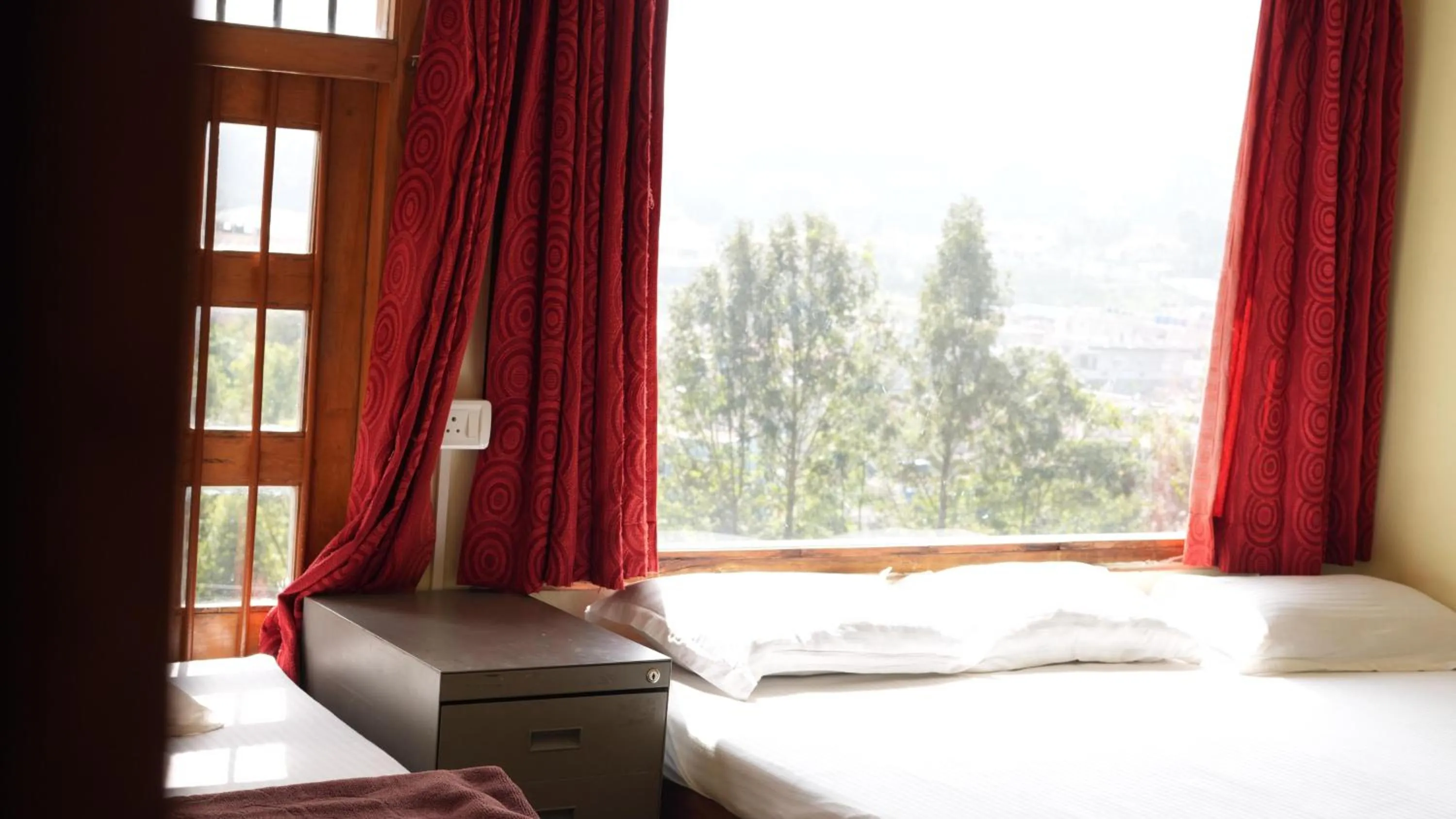 Bed in Satya Anand Cottage Pure Veg and Non Alcoholic Hotel