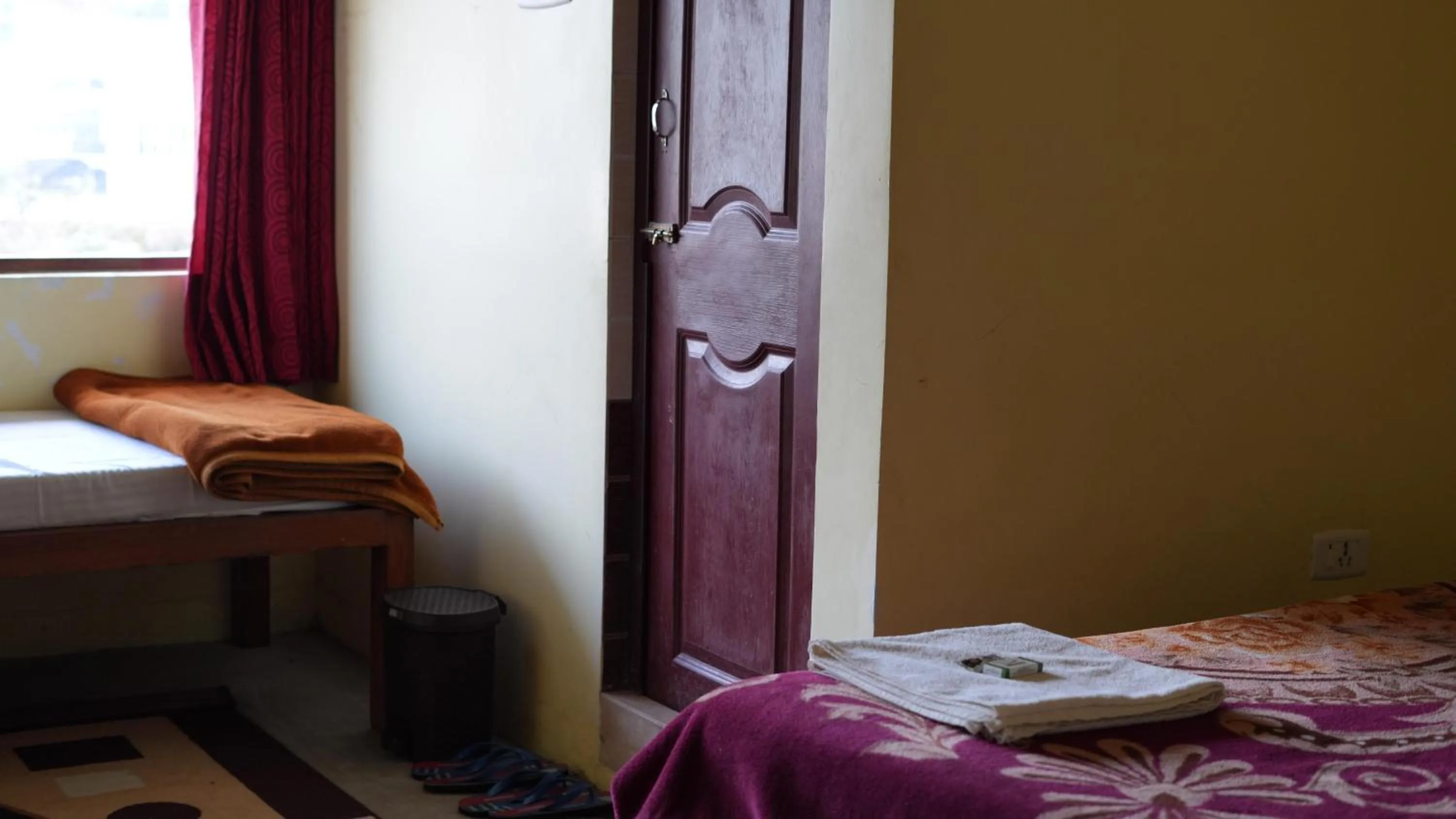 Bed in Satya Anand Cottage Pure Veg and Non Alcoholic Hotel