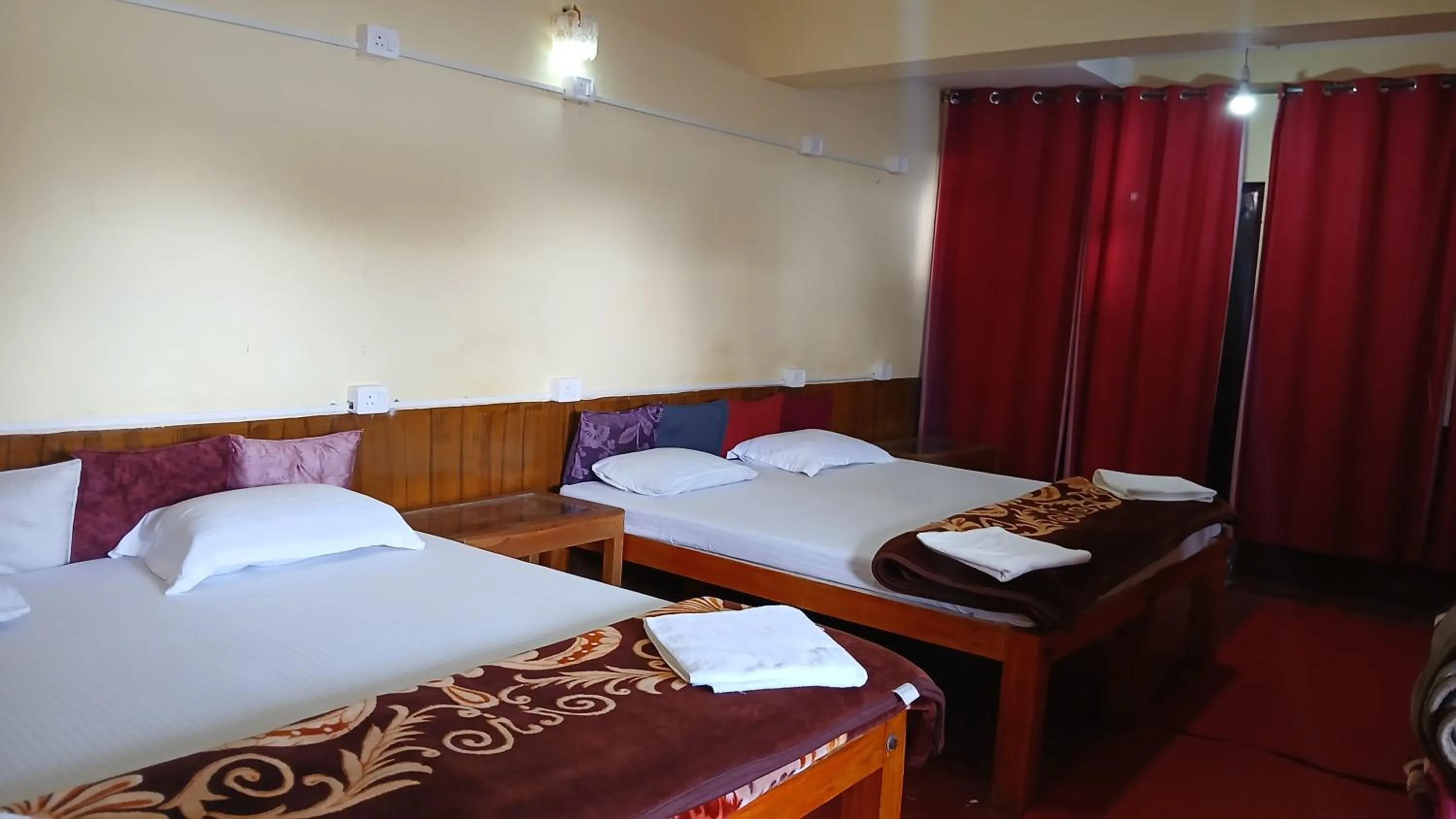 Bed in Satya Anand Cottage Pure Veg and Non Alcoholic Hotel