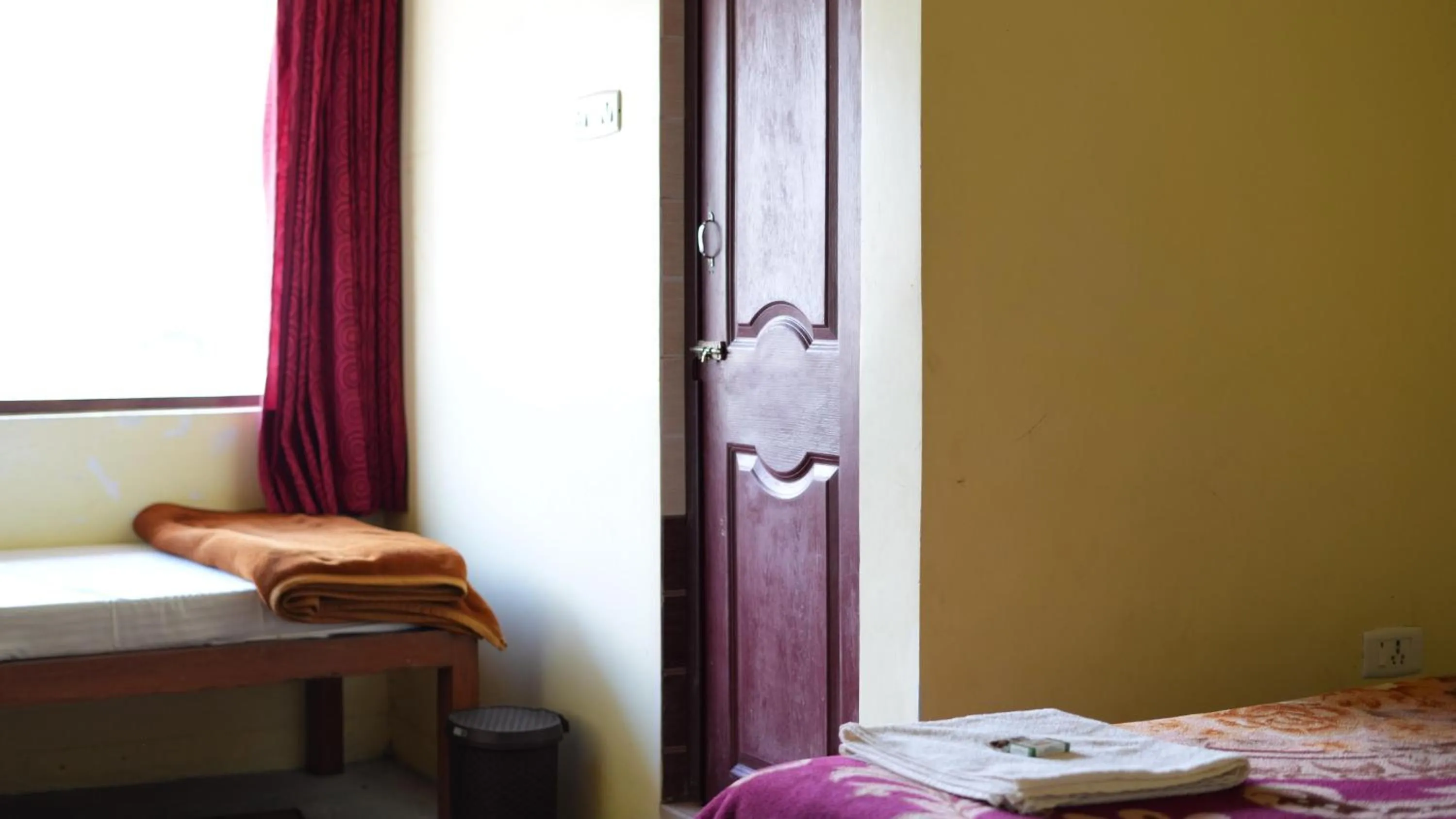 Bed in Satya Anand Cottage Pure Veg and Non Alcoholic Hotel