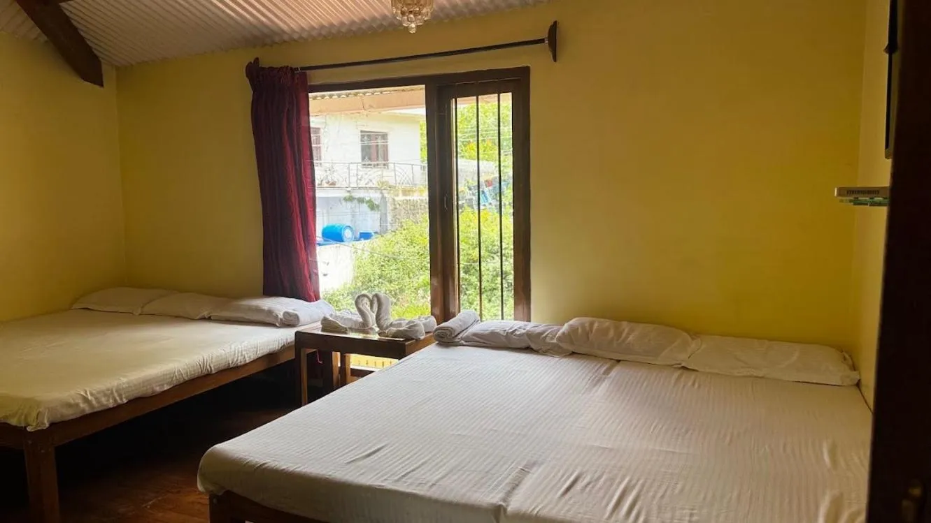 Bed in Satya Anand Cottage Pure Veg and Non Alcoholic Hotel