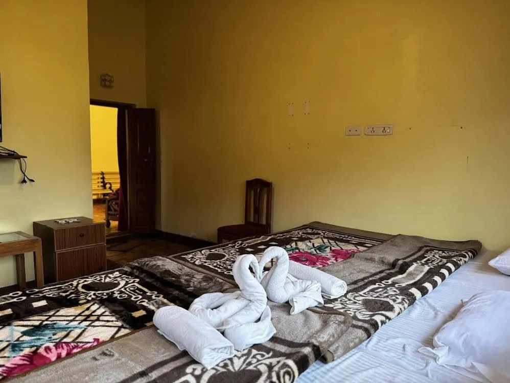 Bed in Satya Anand Cottage Pure Veg and Non Alcoholic Hotel