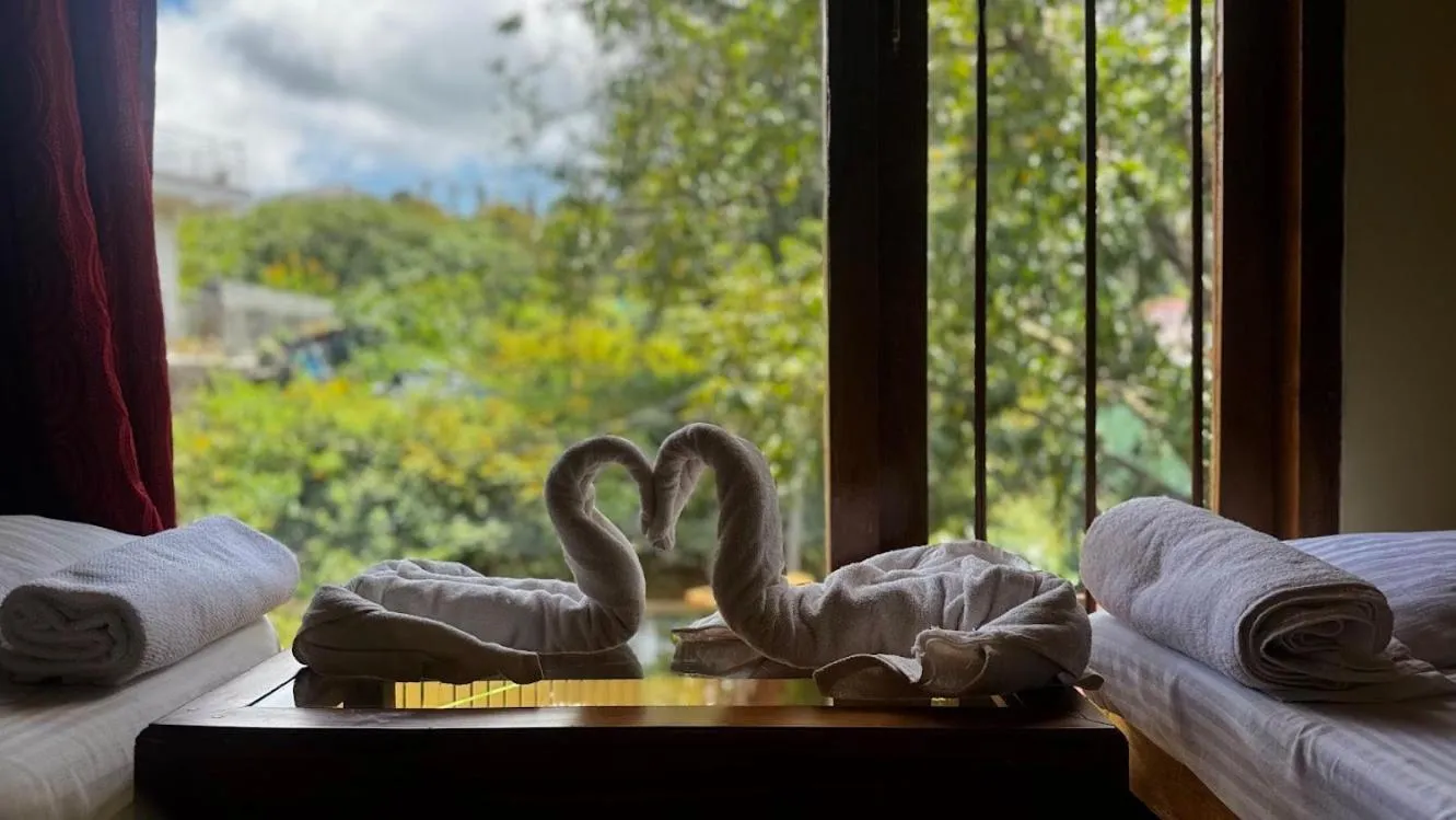 Bed in Satya Anand Cottage Pure Veg and Non Alcoholic Hotel