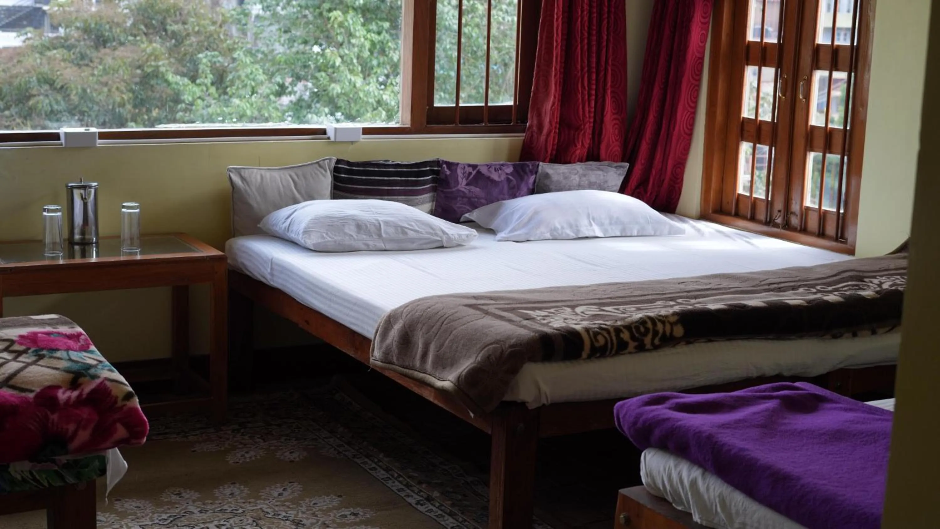 Bed in Satya Anand Cottage Pure Veg and Non Alcoholic Hotel
