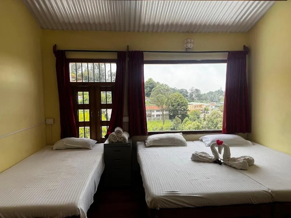 Bed in Satya Anand Cottage Pure Veg and Non Alcoholic Hotel