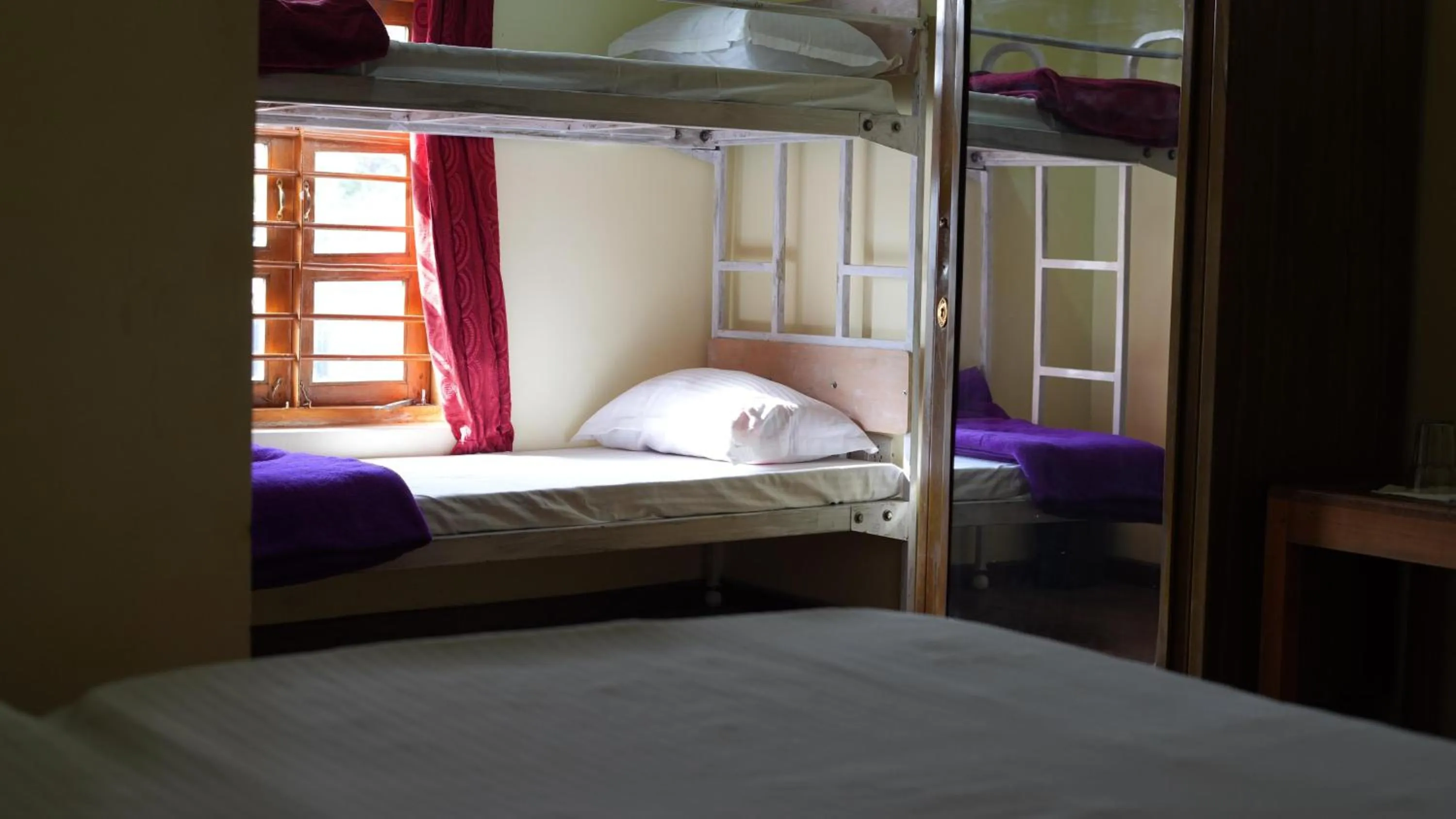 Bed in Satya Anand Cottage Pure Veg and Non Alcoholic Hotel