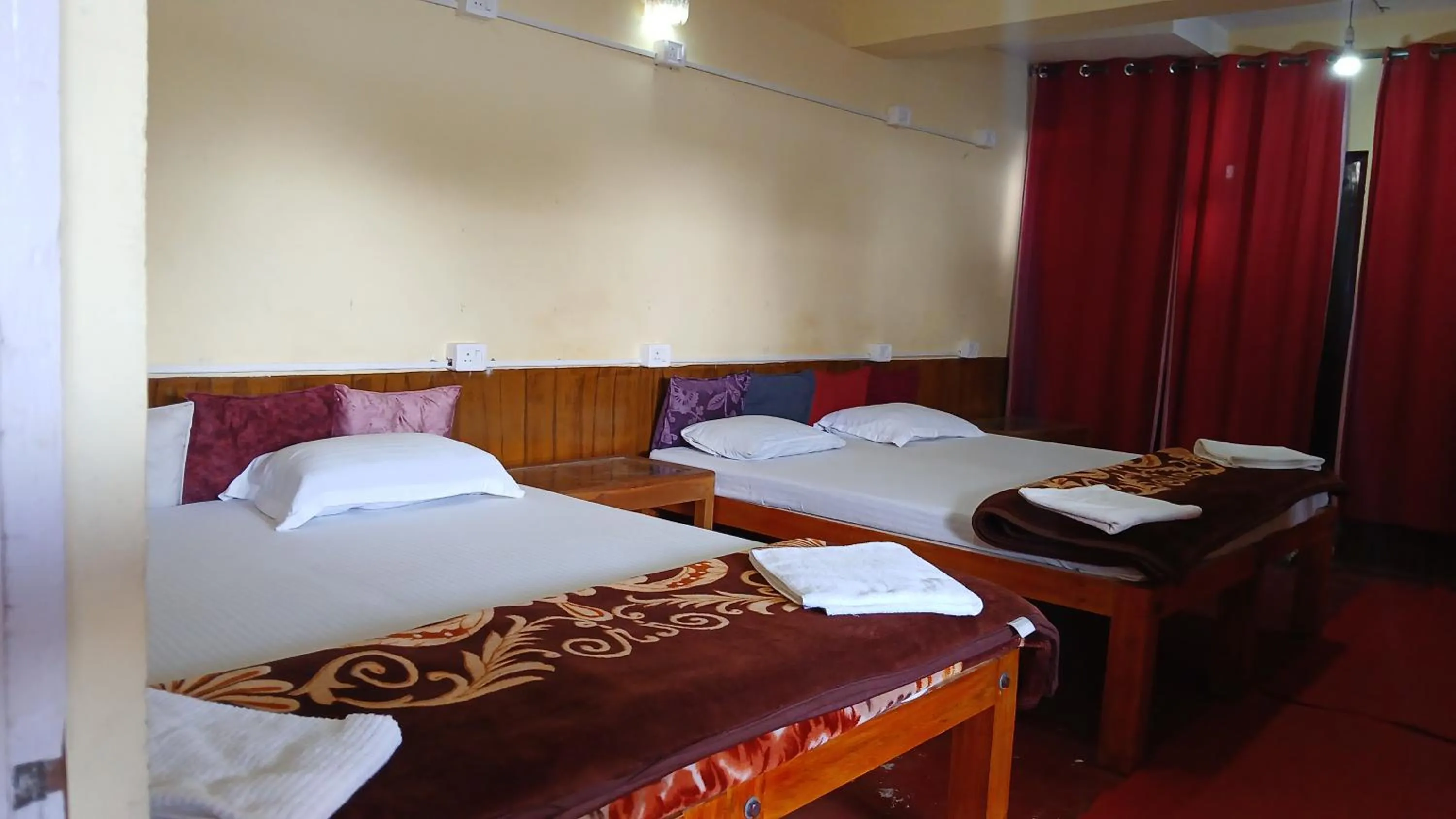 Bed in Satya Anand Cottage Pure Veg and Non Alcoholic Hotel