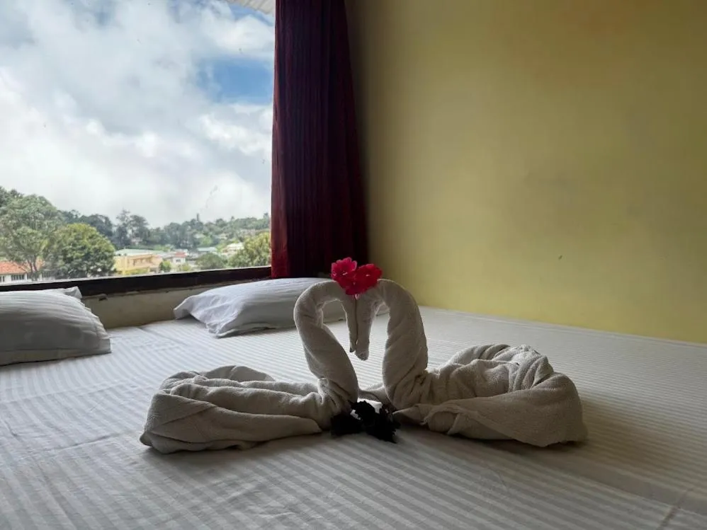 Bed in Satya Anand Cottage Pure Veg and Non Alcoholic Hotel