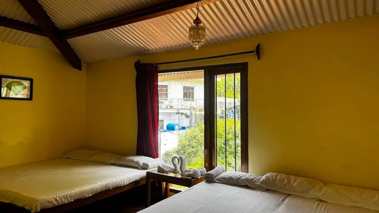 Bed in Satya Anand Cottage Pure Veg and Non Alcoholic Hotel