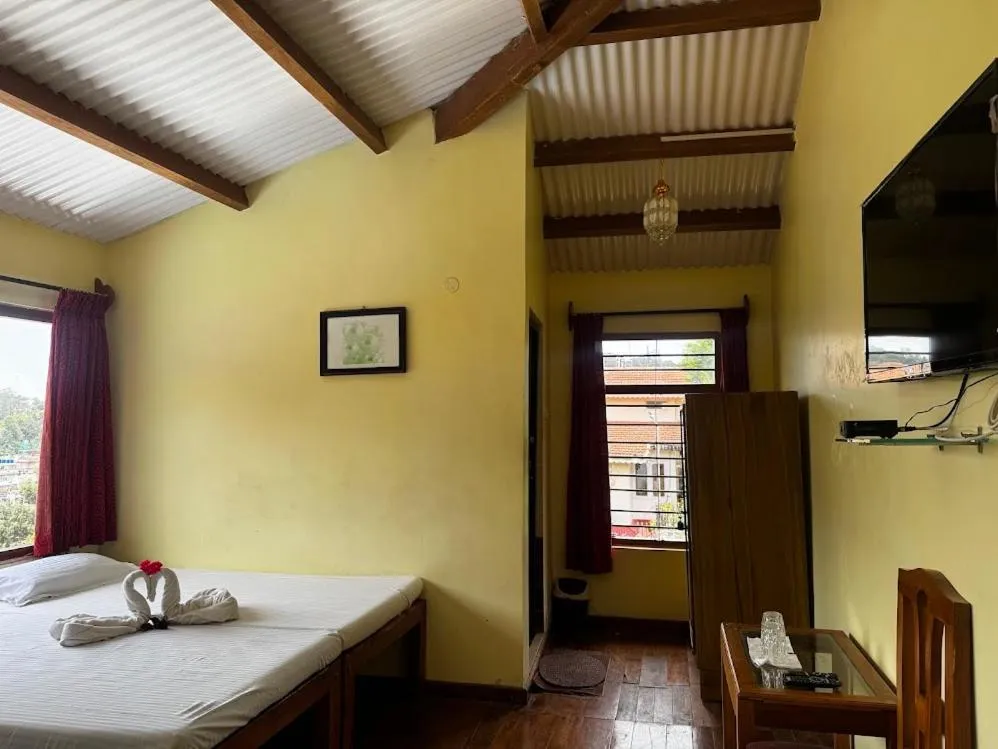 Bed in Satya Anand Cottage Pure Veg and Non Alcoholic Hotel