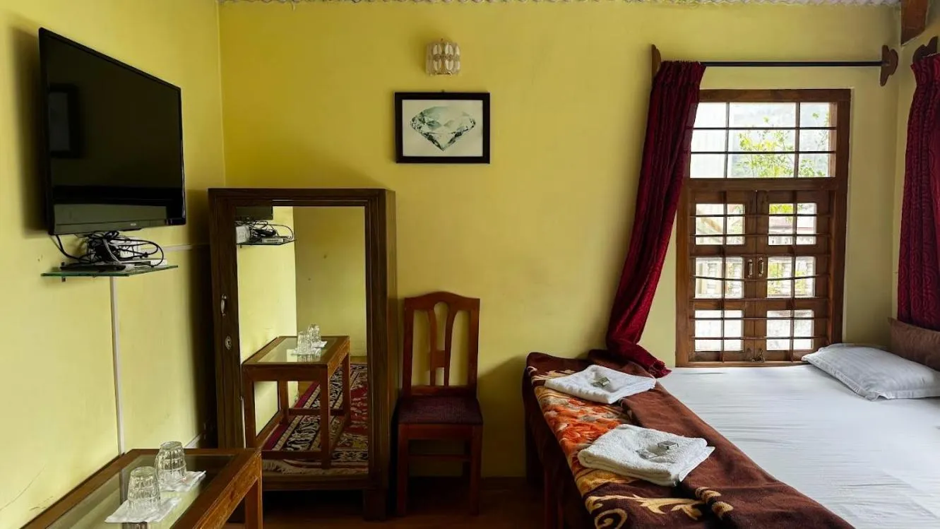 Bed in Satya Anand Cottage Pure Veg and Non Alcoholic Hotel