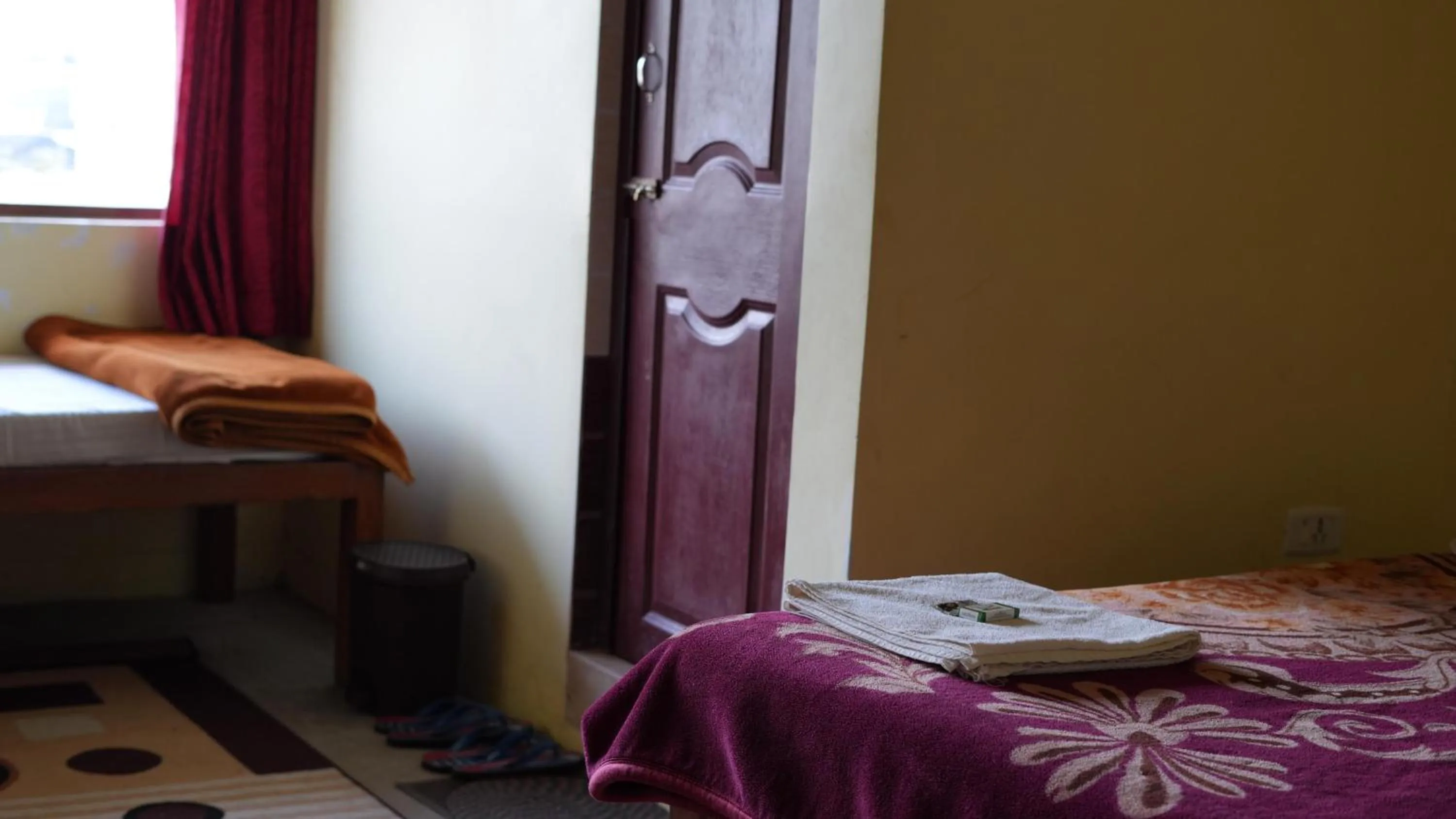 Bed in Satya Anand Cottage Pure Veg and Non Alcoholic Hotel