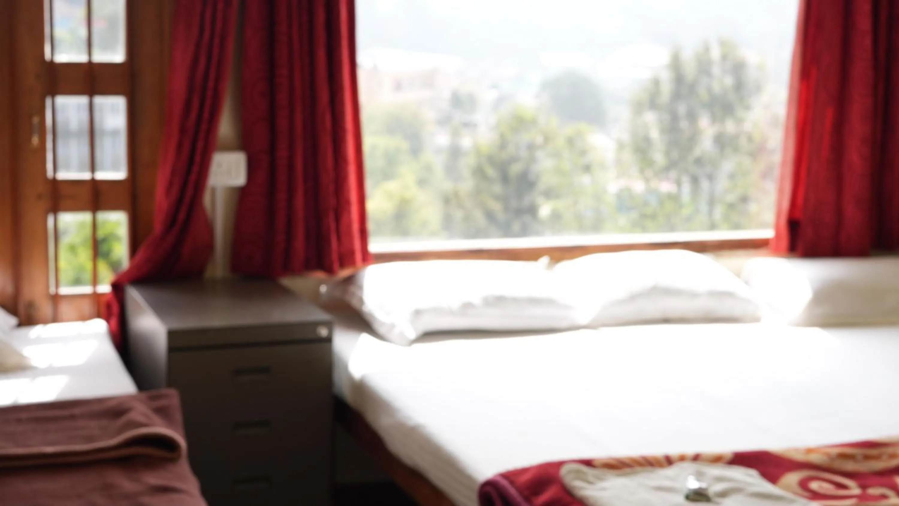 Bed in Satya Anand Cottage Pure Veg and Non Alcoholic Hotel