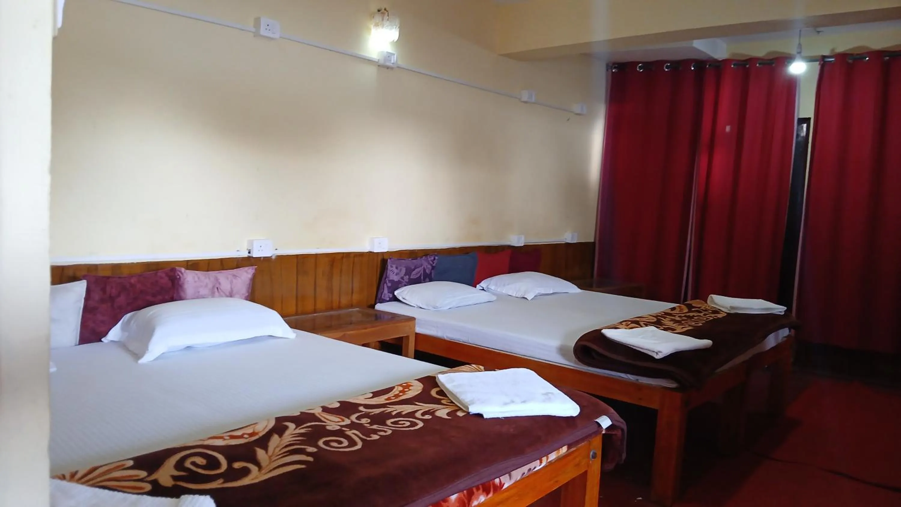 Bed in Satya Anand Cottage Pure Veg and Non Alcoholic Hotel