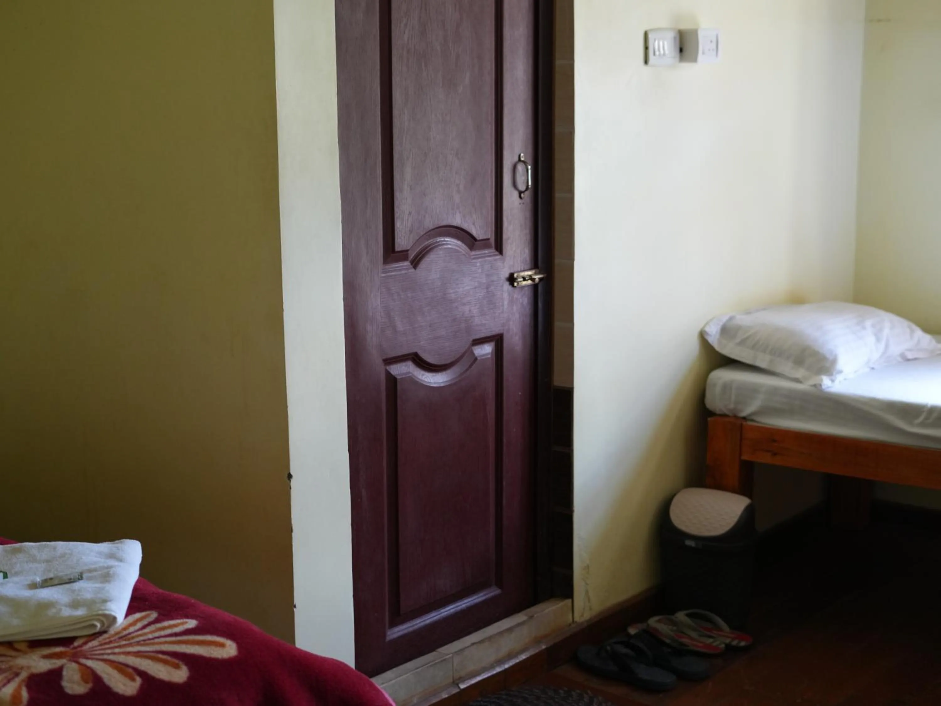 Bed in Satya Anand Cottage Pure Veg and Non Alcoholic Hotel