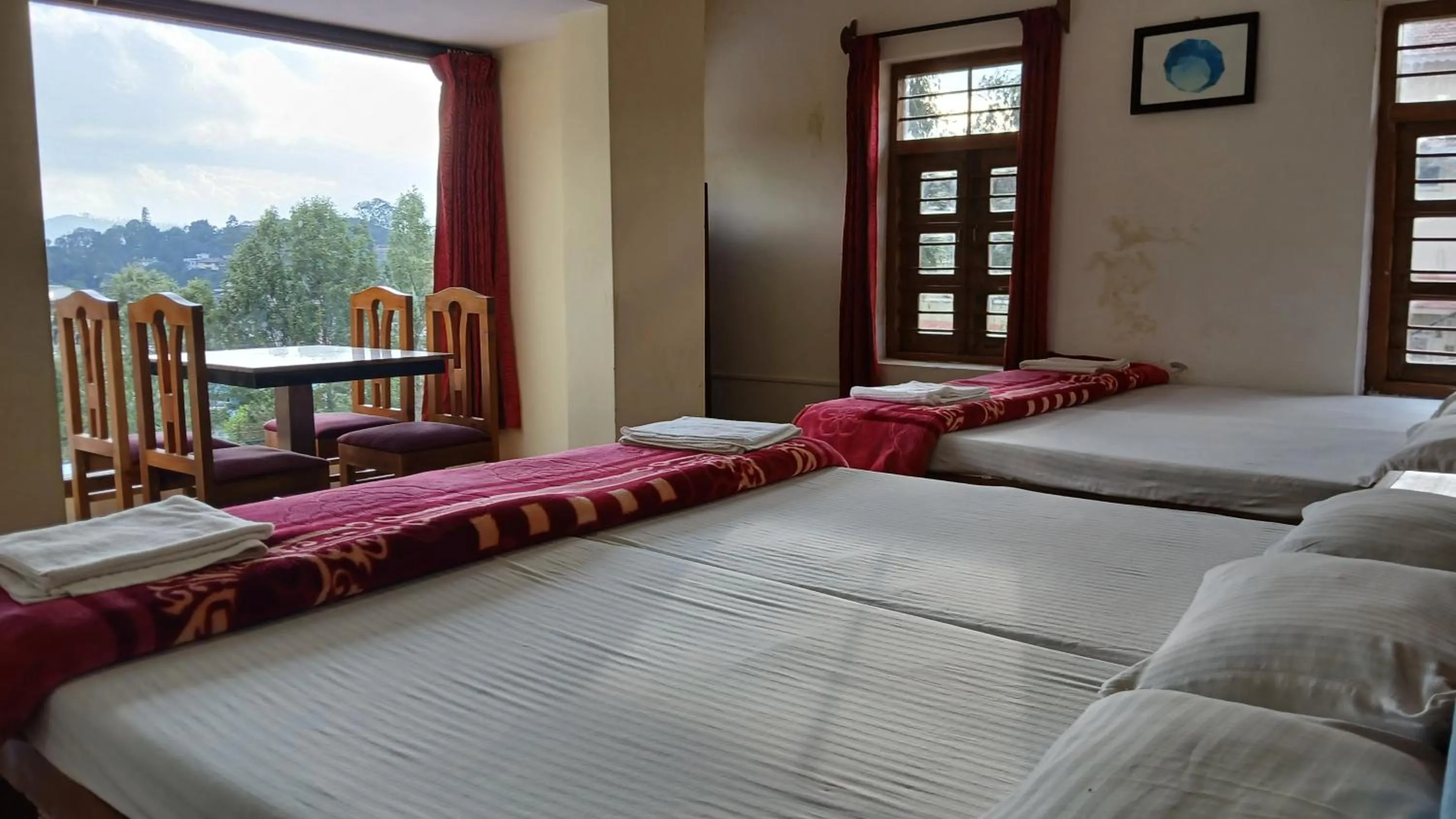 Bed in Satya Anand Cottage Pure Veg and Non Alcoholic Hotel