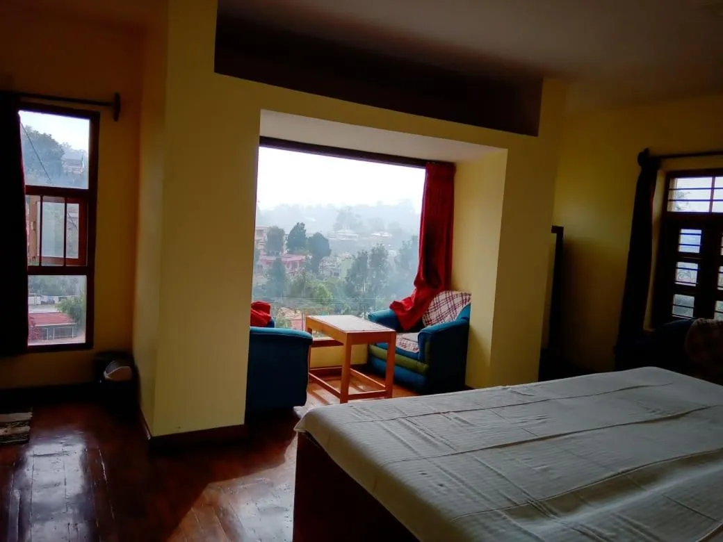 Bed in Satya Anand Cottage Pure Veg and Non Alcoholic Hotel