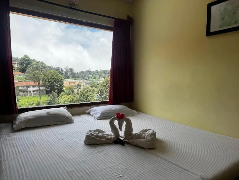 Bed in Satya Anand Cottage Pure Veg and Non Alcoholic Hotel