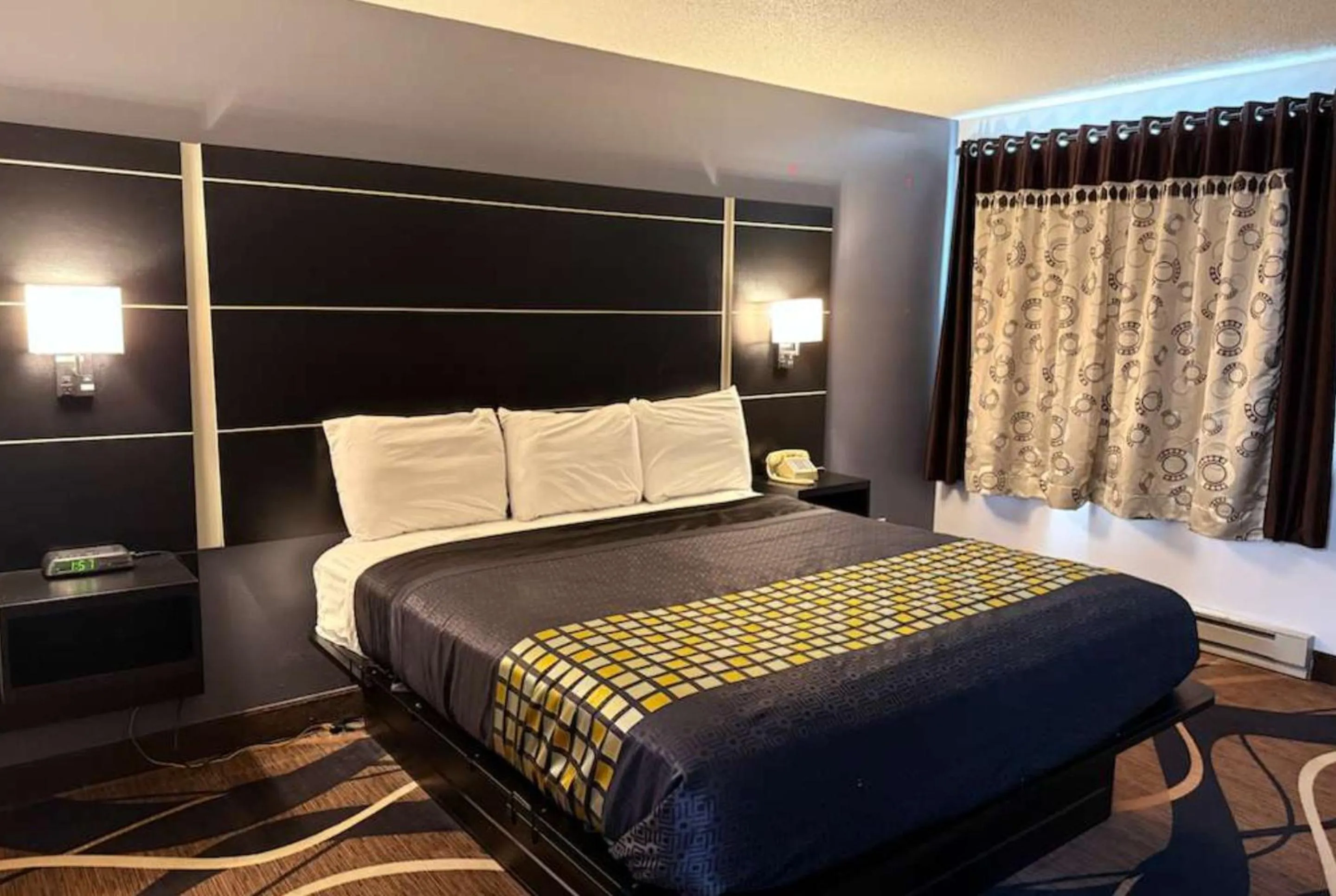 Bed in Coratel Inn & Suites by Jasper Hastings