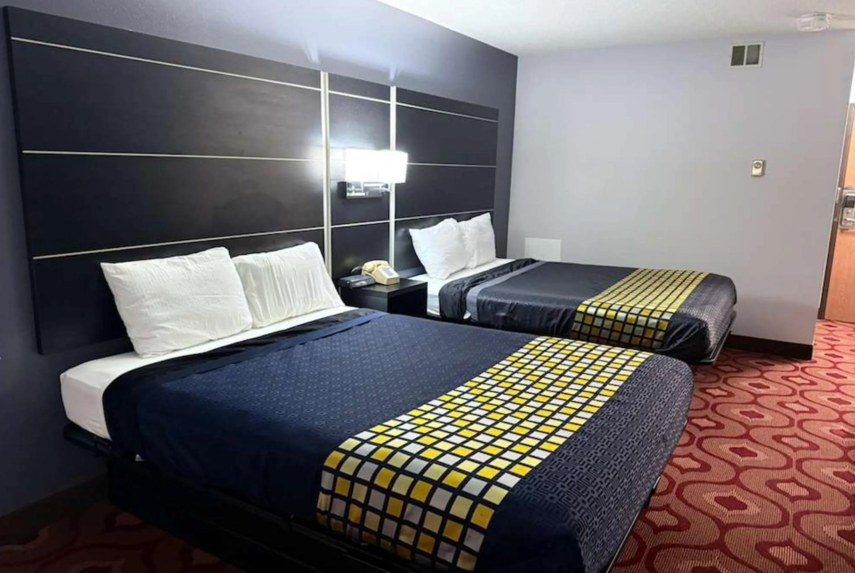 Bed in Coratel Inn & Suites by Jasper Hastings