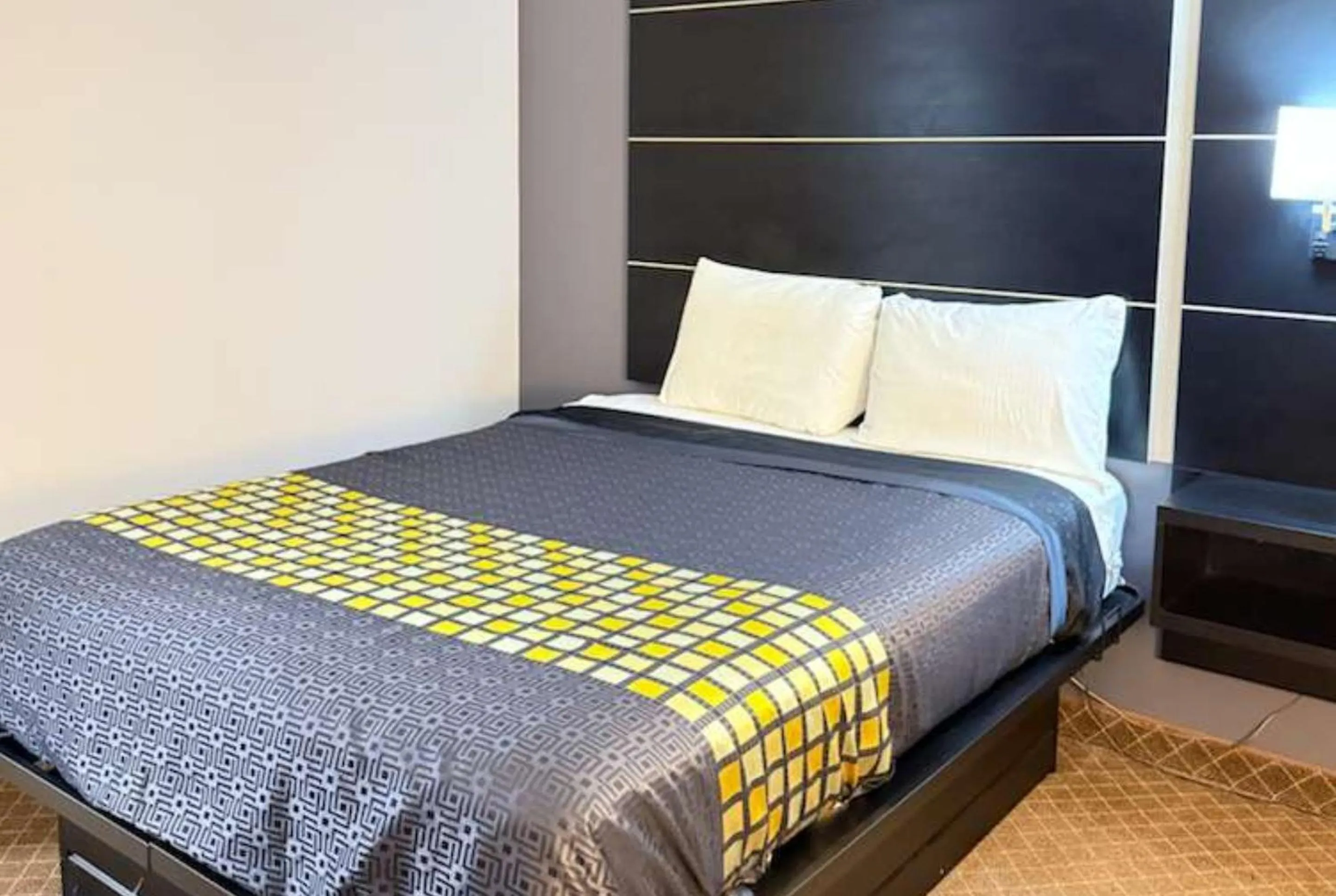 Bed in Coratel Inn & Suites by Jasper Hastings