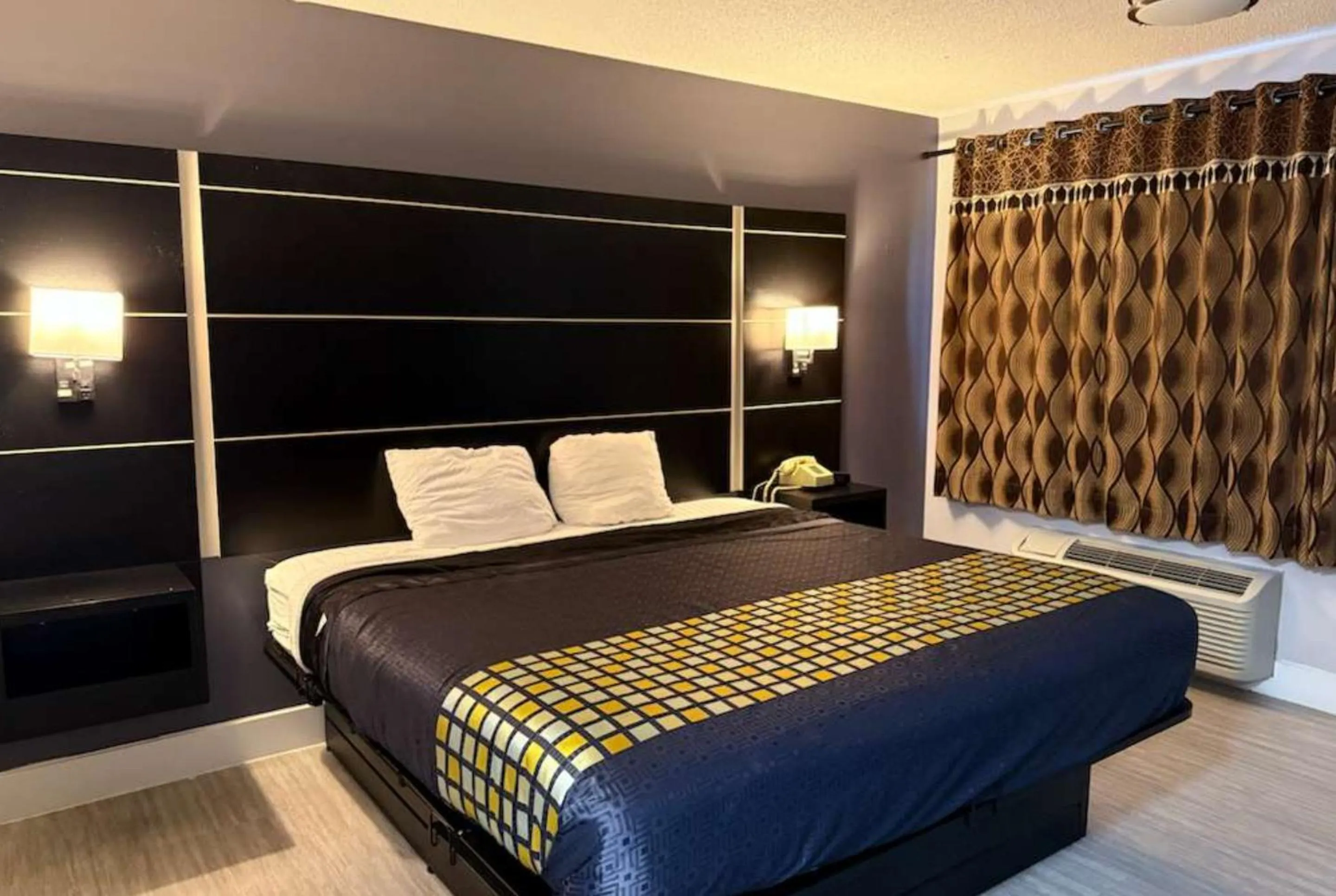 Bed in Coratel Inn & Suites by Jasper Hastings