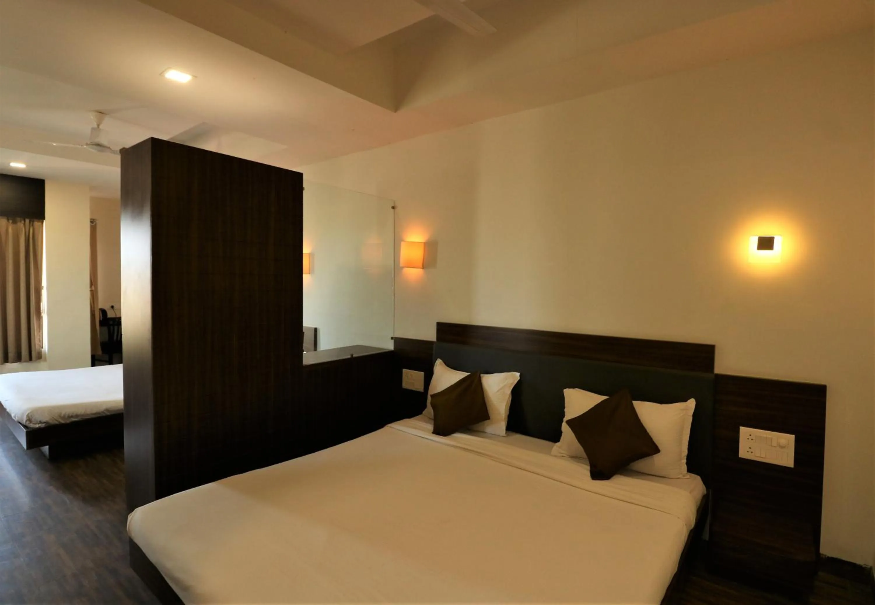 Photo of the whole room, Bed in Goverdhan Greens Resort Dwarka l Hotels In Dwarka