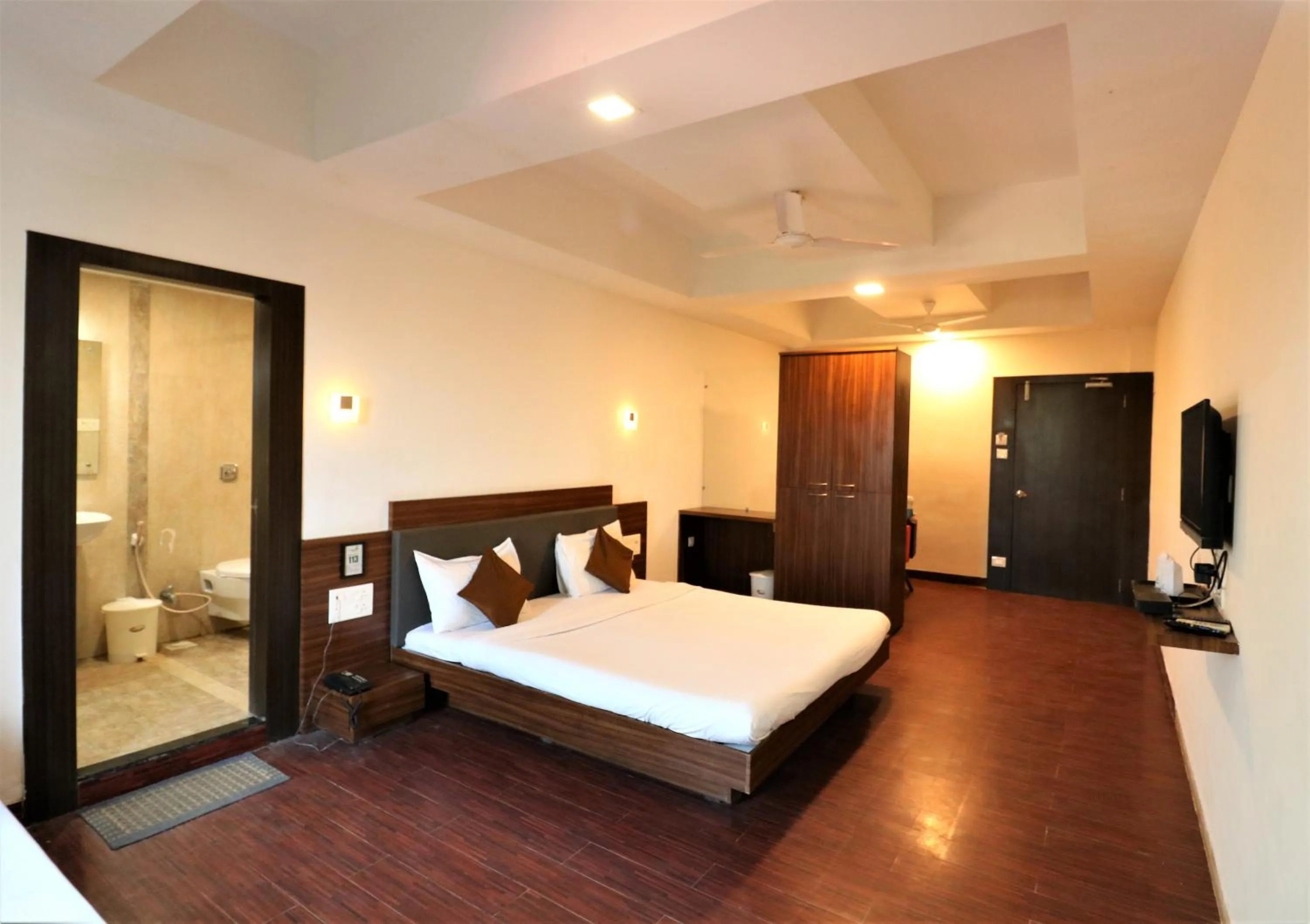 Photo of the whole room, Bed in Goverdhan Greens Resort Dwarka l Hotels In Dwarka
