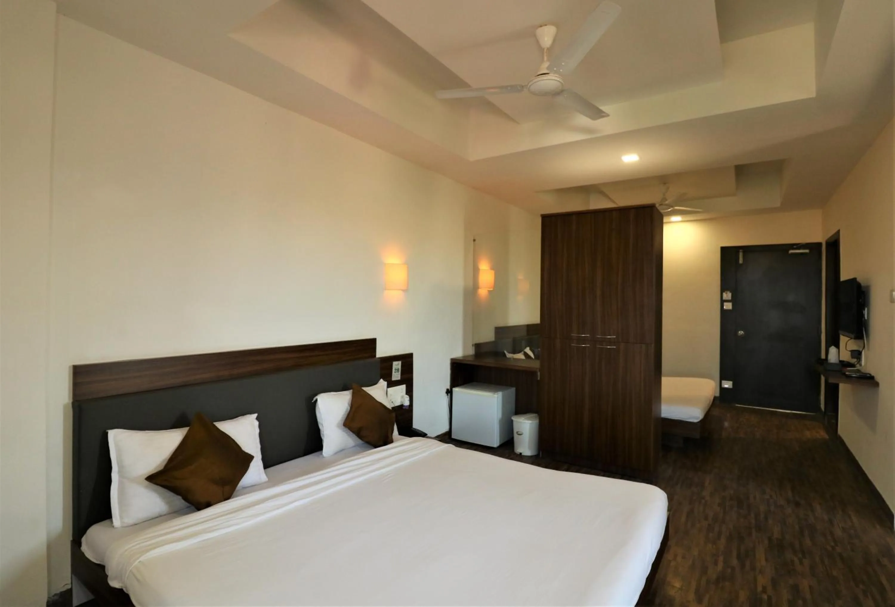 Photo of the whole room, Bed in Goverdhan Greens Resort Dwarka l Hotels In Dwarka
