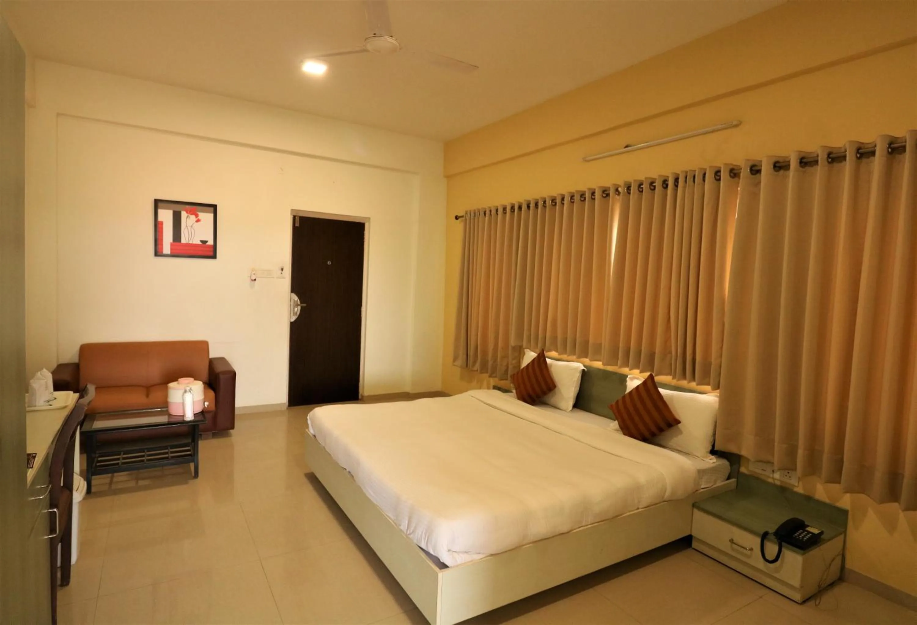 Photo of the whole room, Bed in Goverdhan Greens Resort Dwarka l Hotels In Dwarka