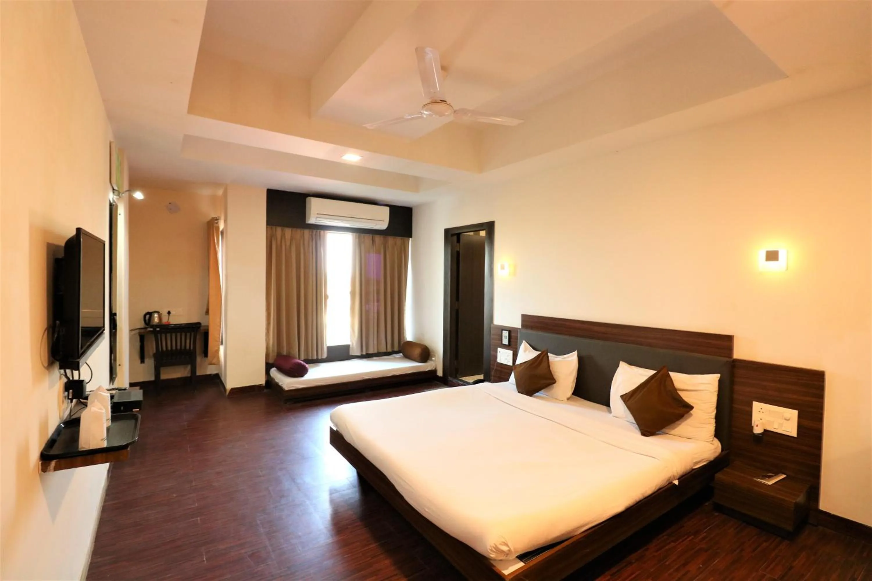 Photo of the whole room, Bed in Goverdhan Greens Resort Dwarka l Hotels In Dwarka