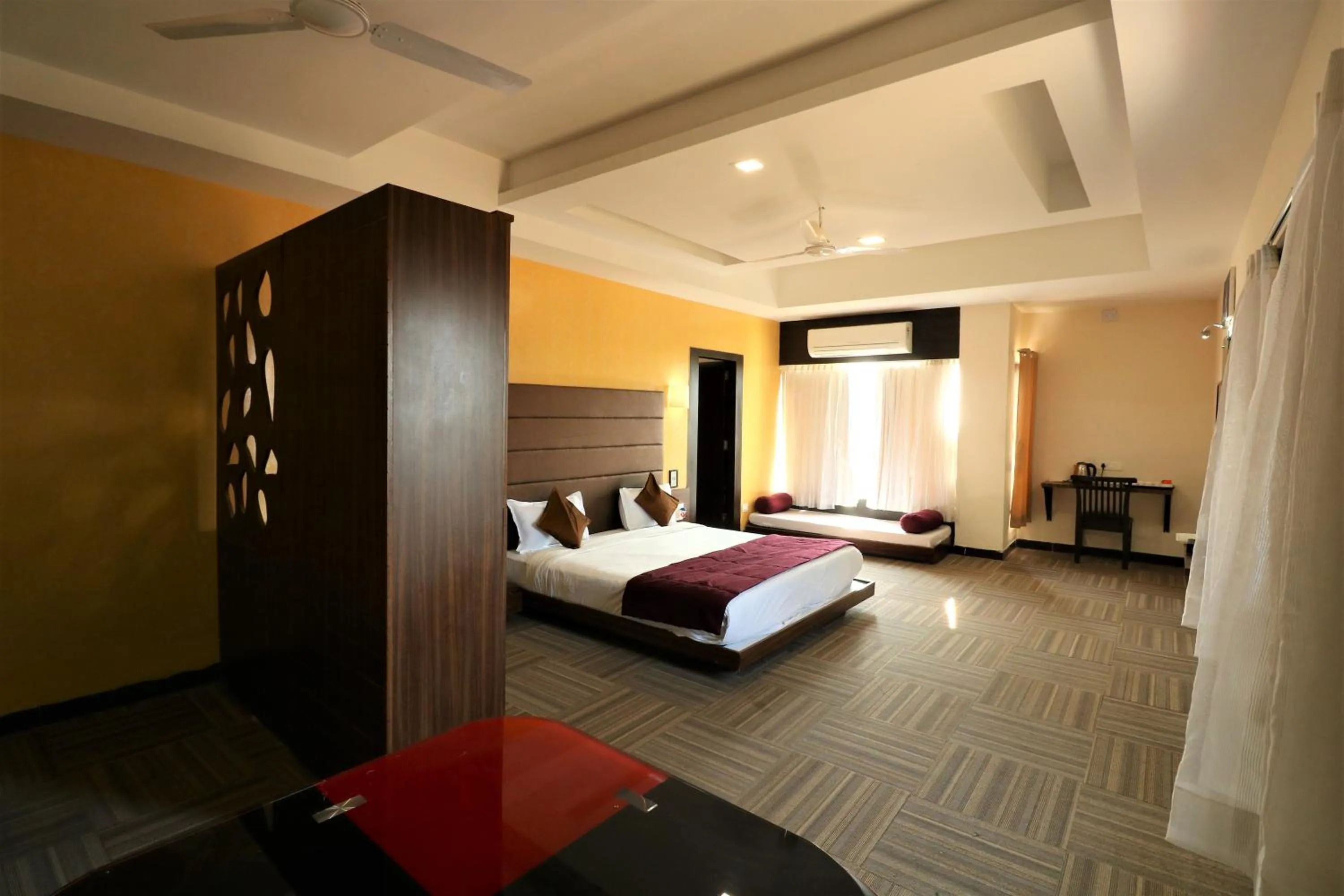 Photo of the whole room, Bed in Goverdhan Greens Resort Dwarka l Hotels In Dwarka