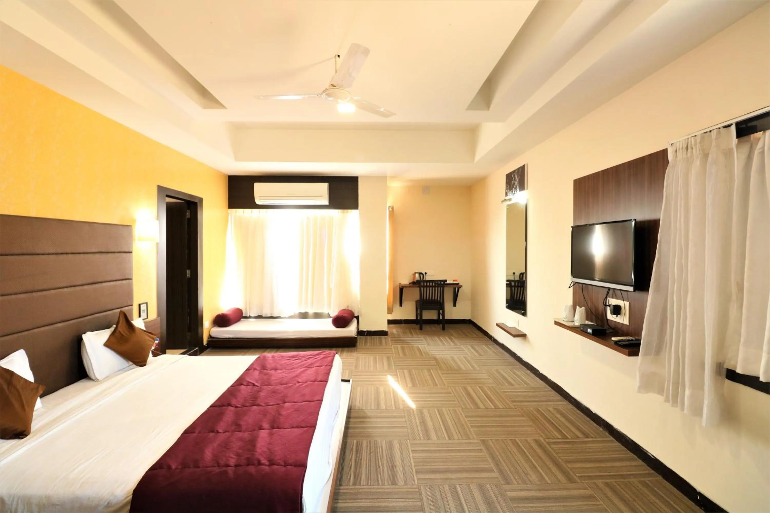 Photo of the whole room, Bed in Goverdhan Greens Resort Dwarka l Hotels In Dwarka