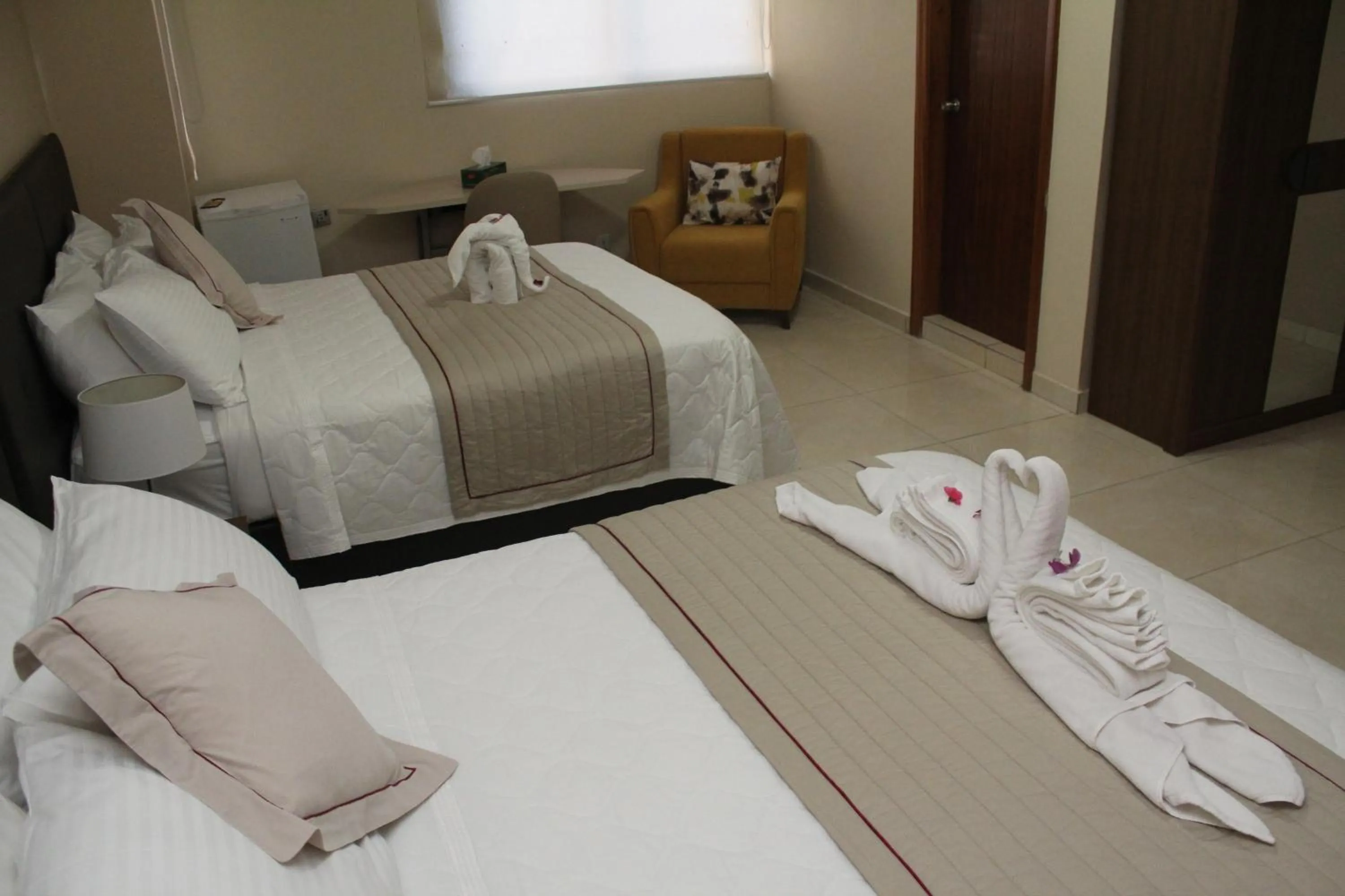Bed in Murex Plaza Hotel & Suites