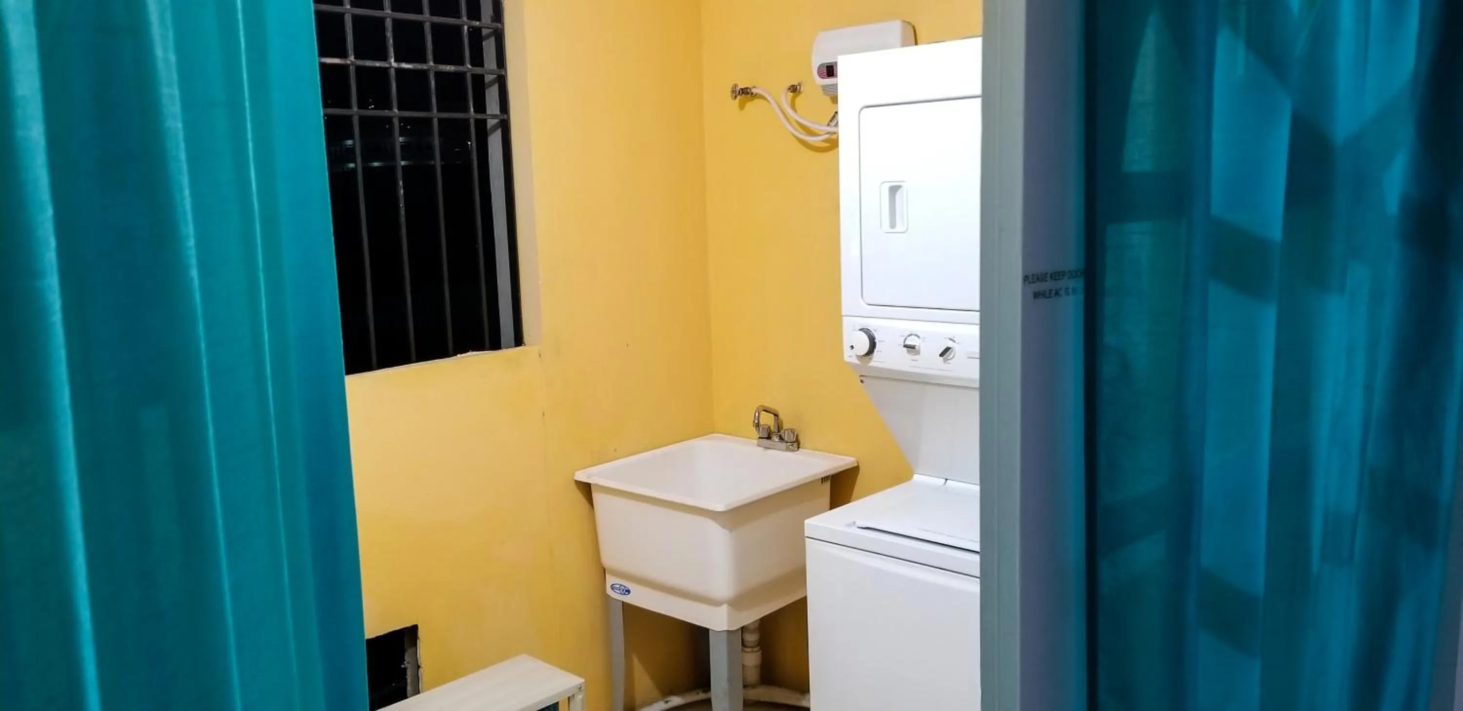 washing machine in New Kingston Guest Apartments @ Donhead